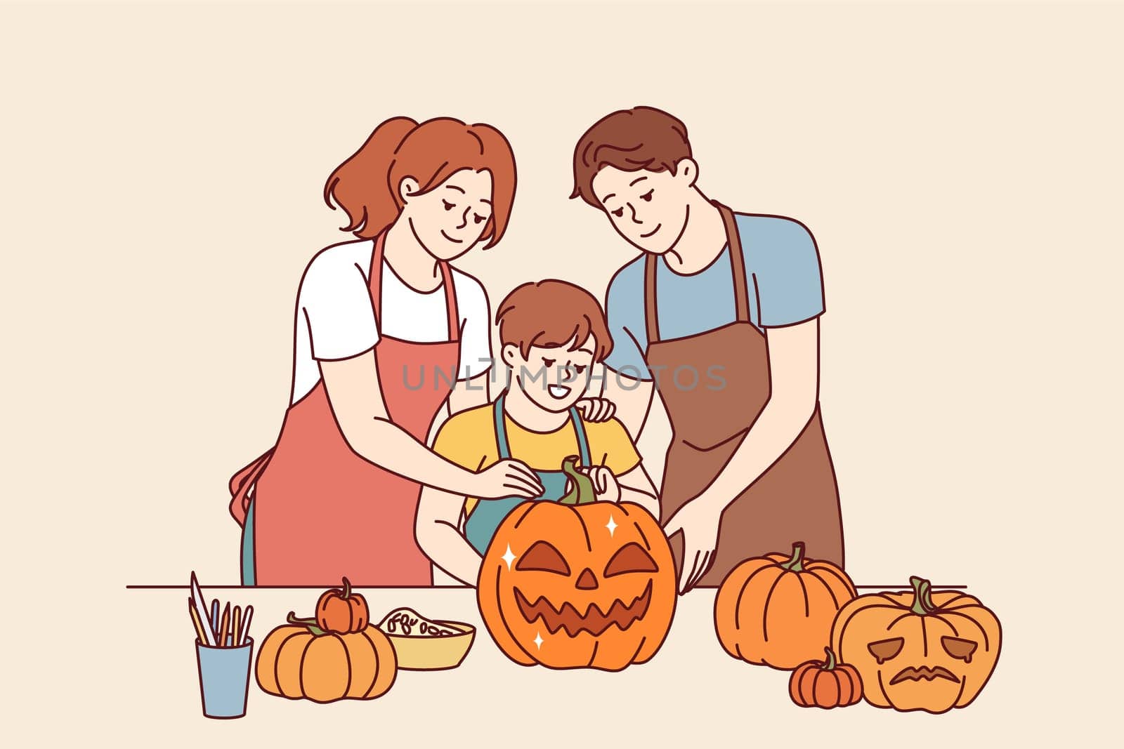 Happy family makes halloween pumpkins to decorate house for october 31st and celebrate all saints day. Boy together with parents, dressed in aprons, cuts out jack-o-lanterns for celebration halloween
