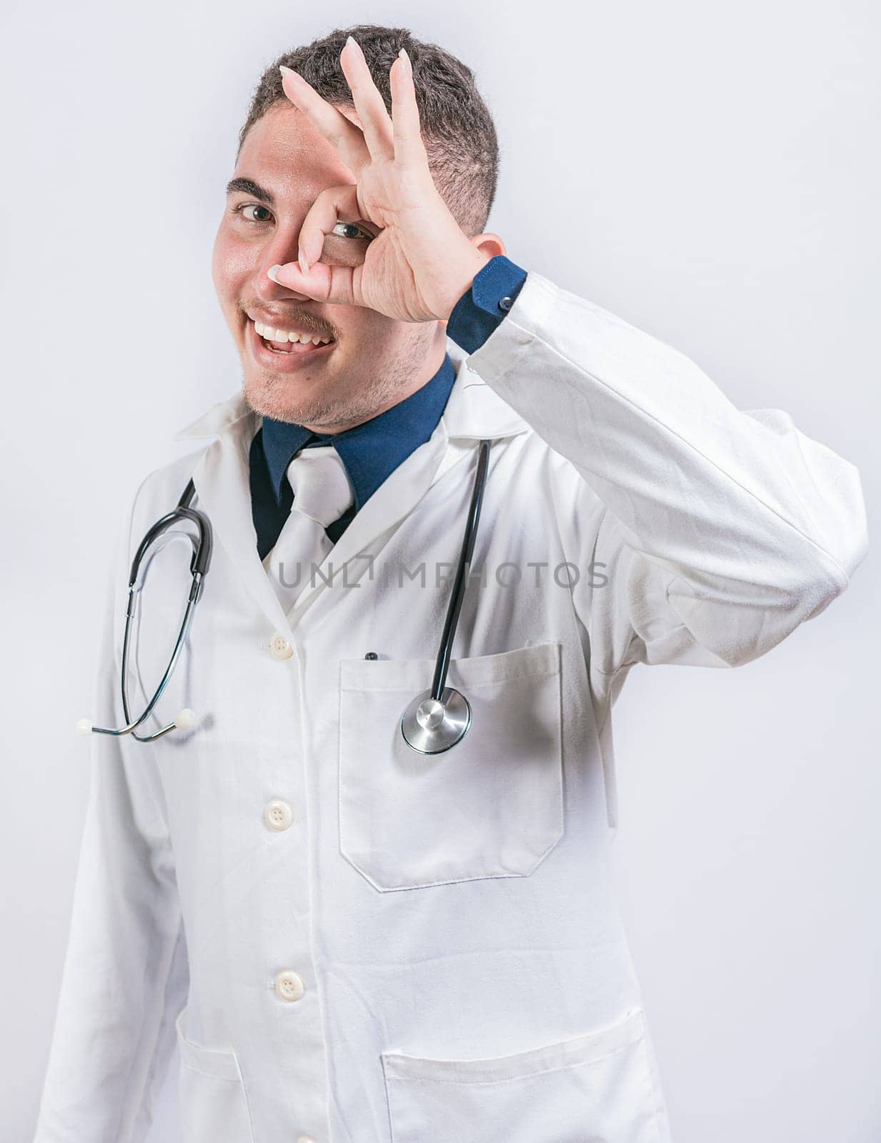 Cheerful doctor gesturing approval isolated. Latin doctor approving on isolated background, Handsome doctor approving and recommending