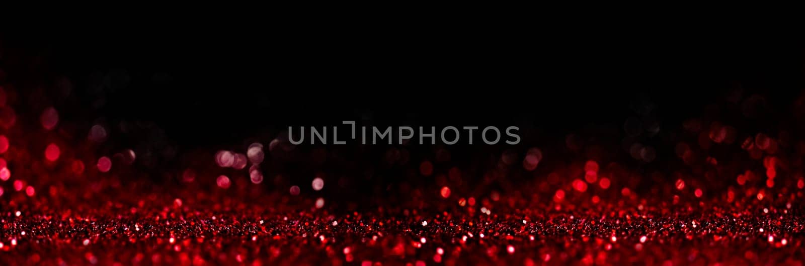 Abstract blur red glitter on black background. Card for Valentine's day, christmas and wedding celebration. Love bokeh sparkle confetti textured layout. Classy elegant design.