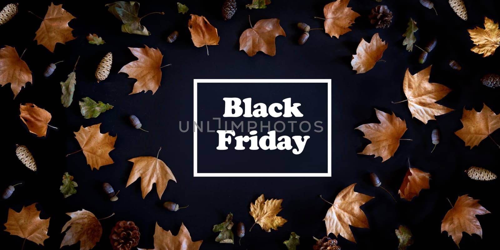 Autumn maple leaves frame on dark background with copyspace from above. November black friday sale and thanksgiving concept. Fall season natural flat lay border.