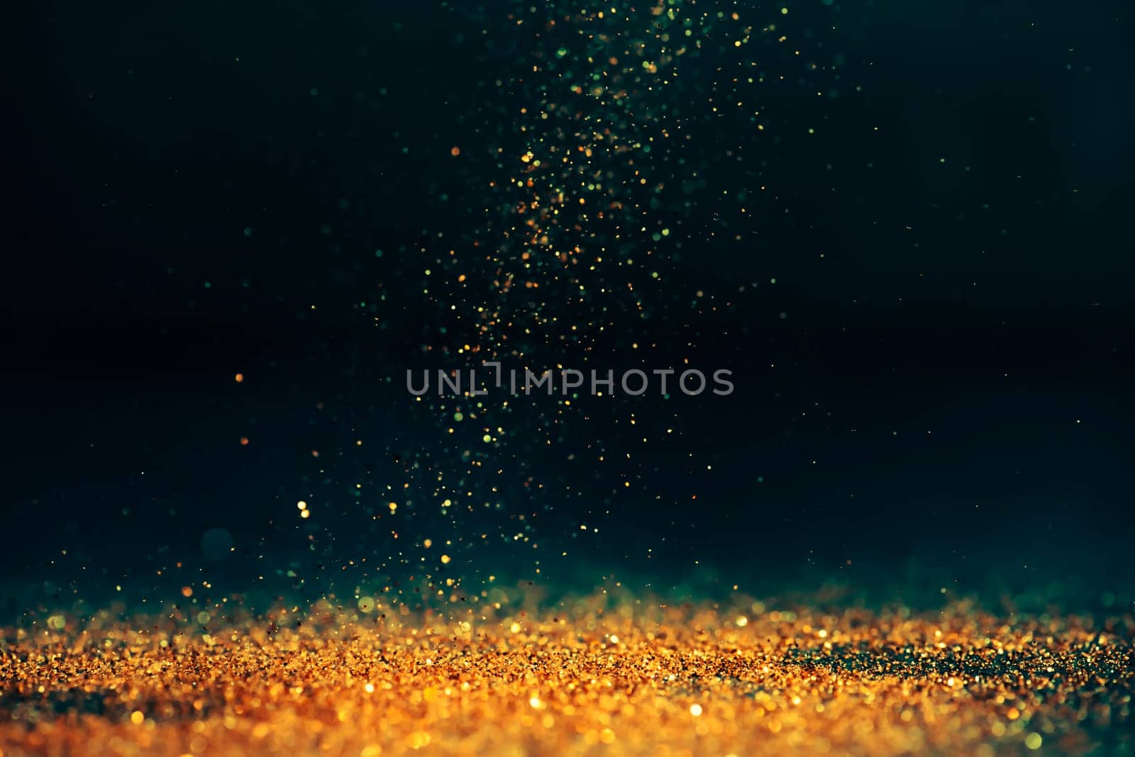 Luxury abstract glitter bokeh background. New year and christmas holiday party design. Golden star dust light sparkling on dark backdrop.