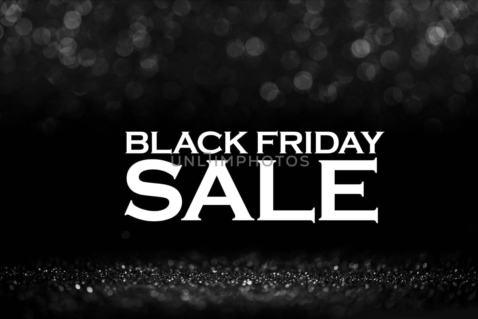 Black friday bokeh background. Elegant dark blur layout design. Silver and black glitter place on table with spotlight. Luxury abstract banner with copyspace.