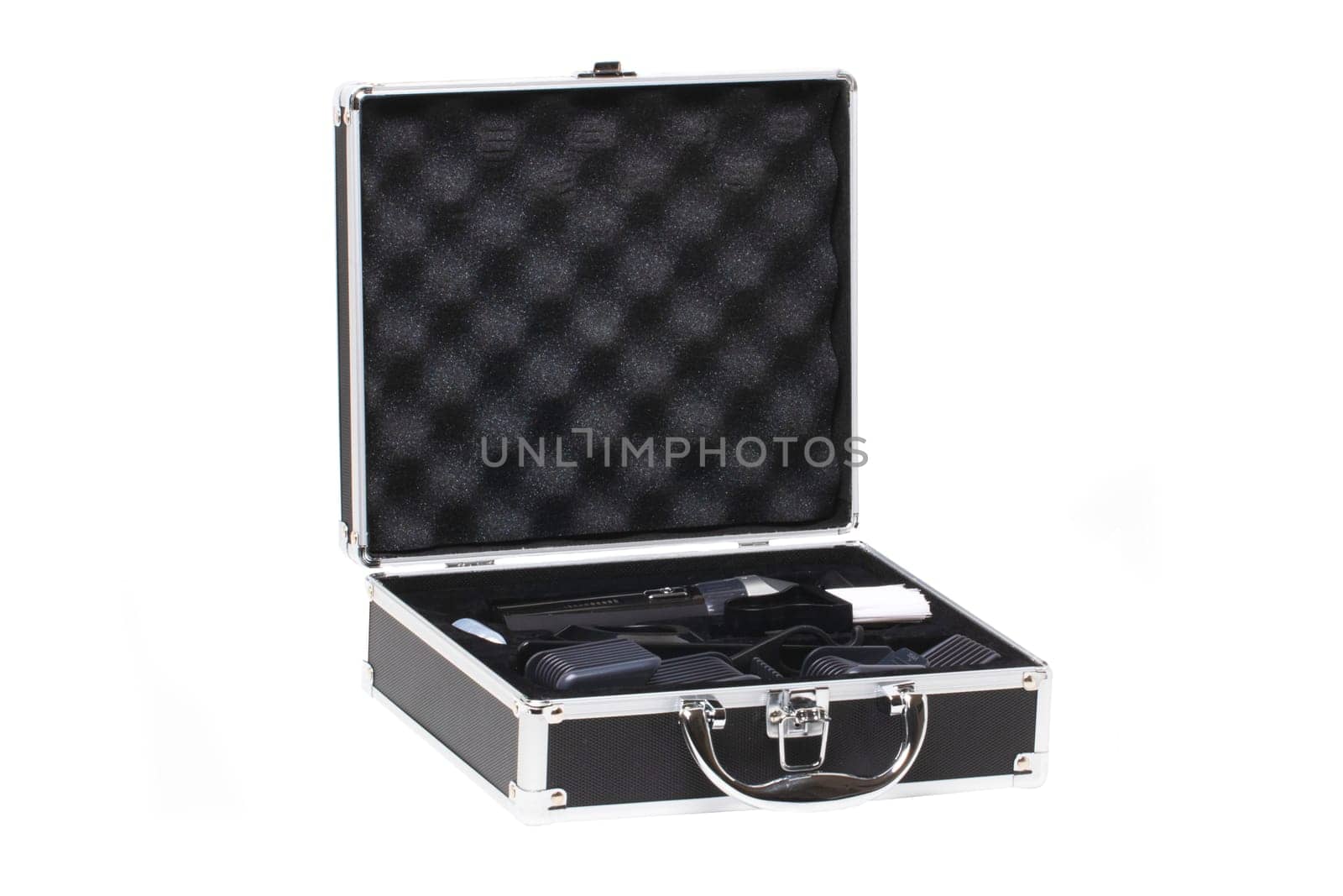 Closeup of a opened small black silver equipment case or suitcase with professional hairdresser's set isolated on a white background.