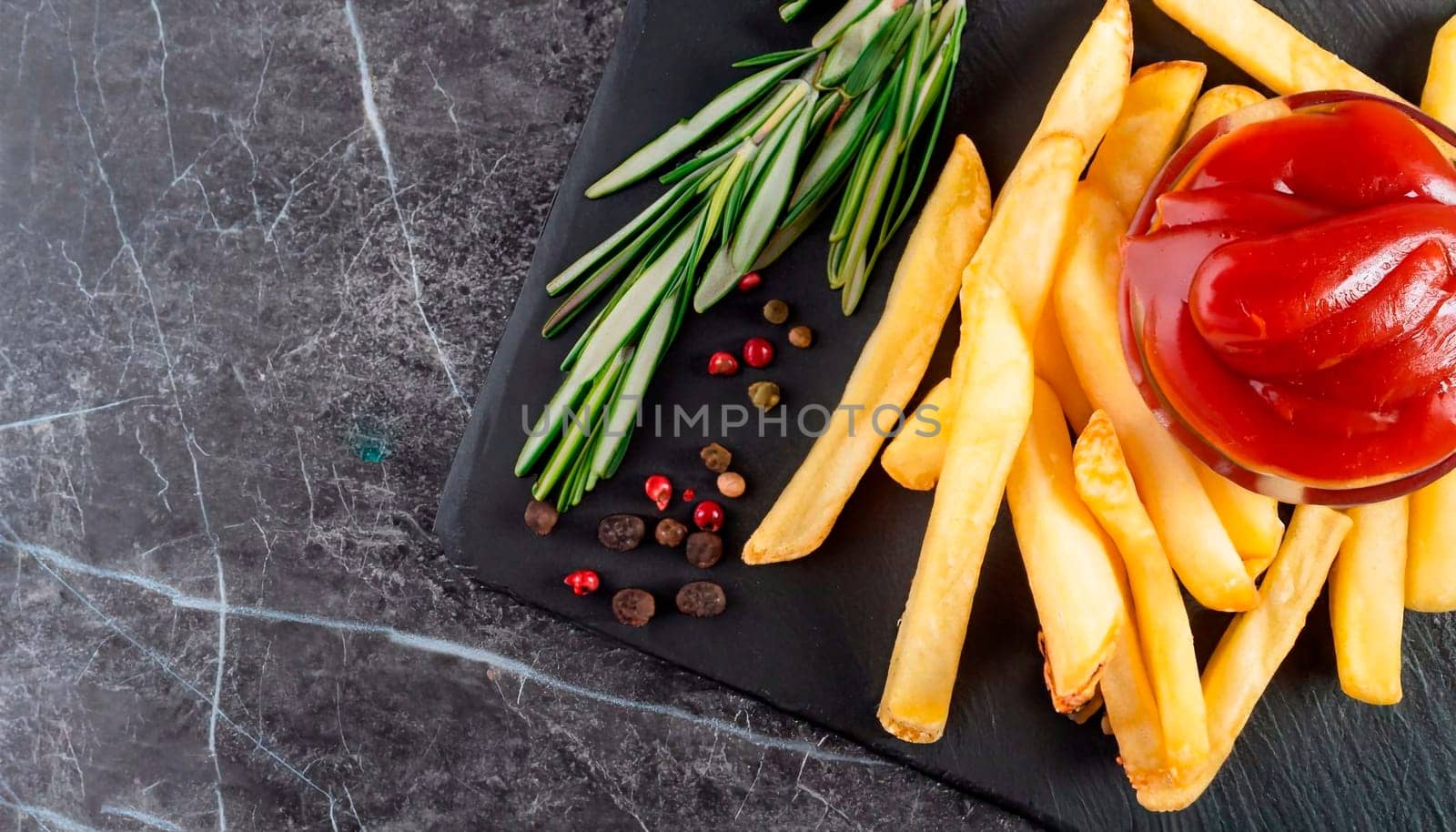 Club sandwich with french fries and ketchup on black tray isolated on marble.