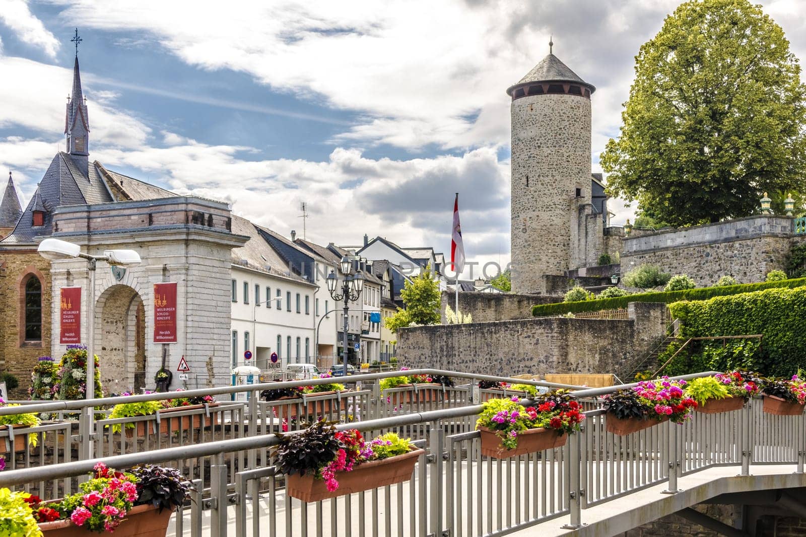 WEILBURG, GERMANY - 06-28-2023: City gate, terraces of Weilburg Castle Park seen from König-Konrad-Platz in Lahntal, Hesse, Germany
