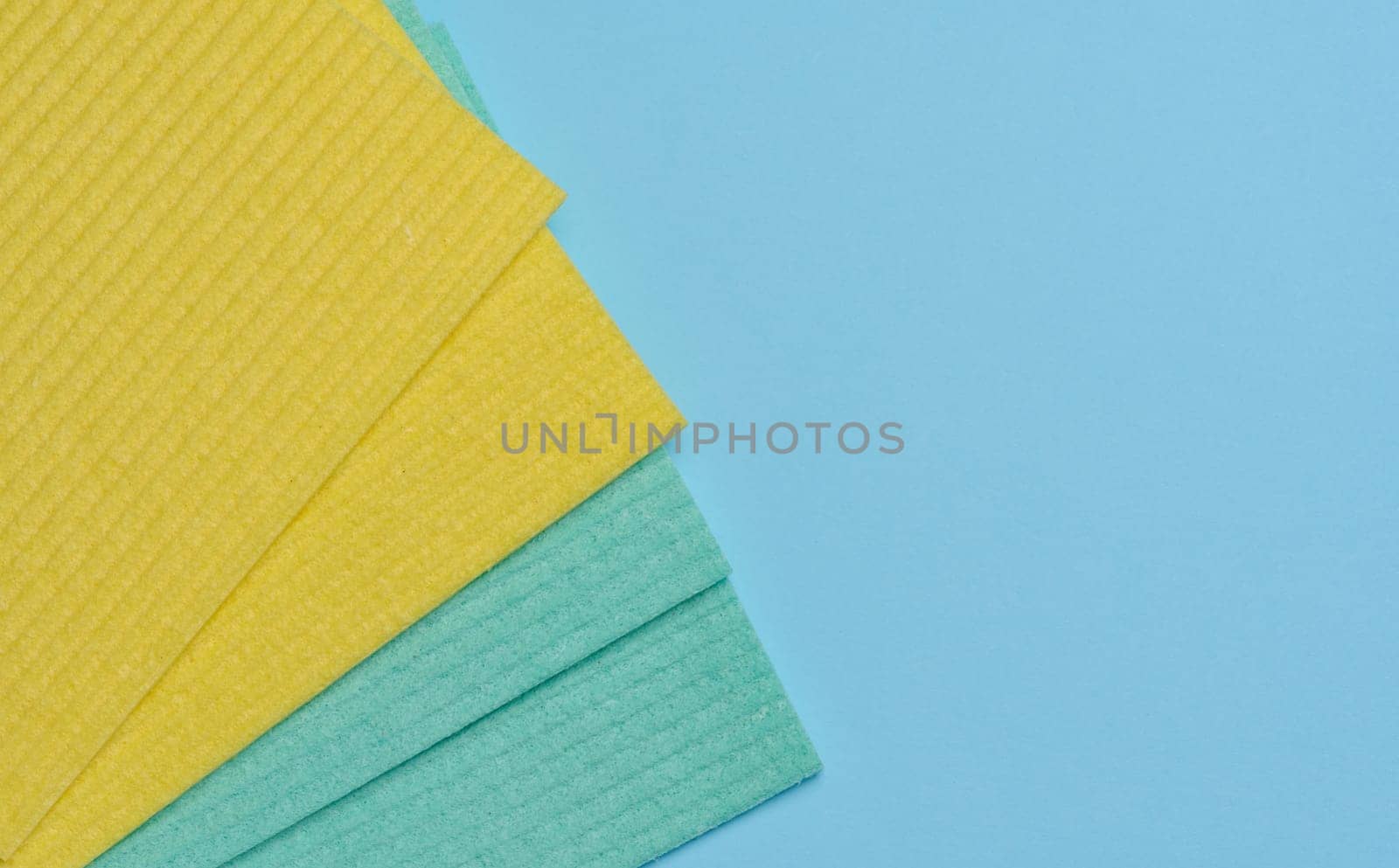 Square sponges for the kitchen and home on a blue background