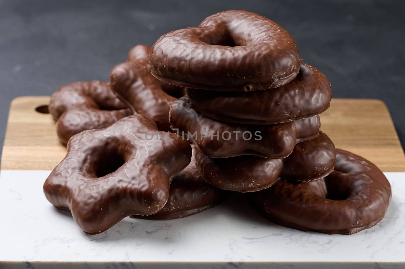 Chocolate gingerbread cookies on black table, top view
