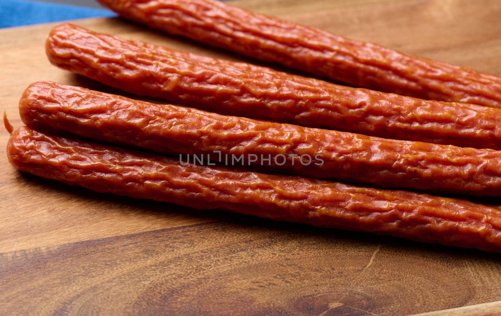 Traditional Polish thin smoked sausages on a black background