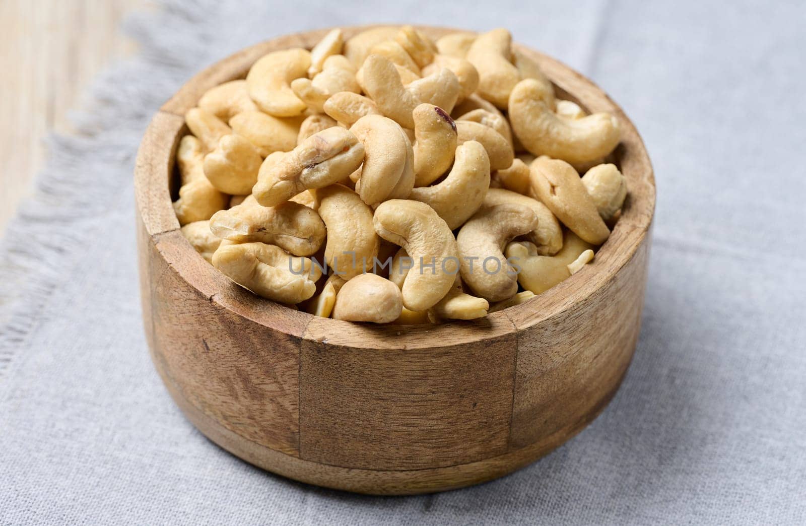 Cashews in a wooden bowl on the table