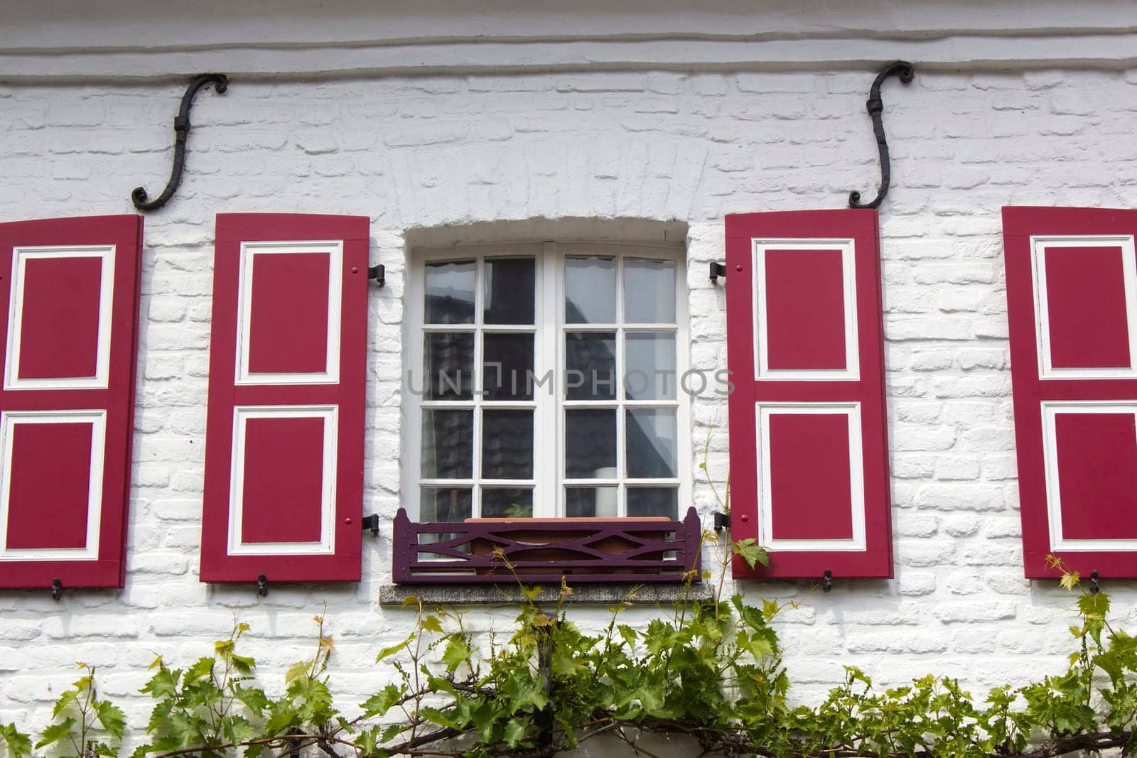Old German house with windows with wooden shutters, Wachtendonk, North-Rhine Westphalia, Germany