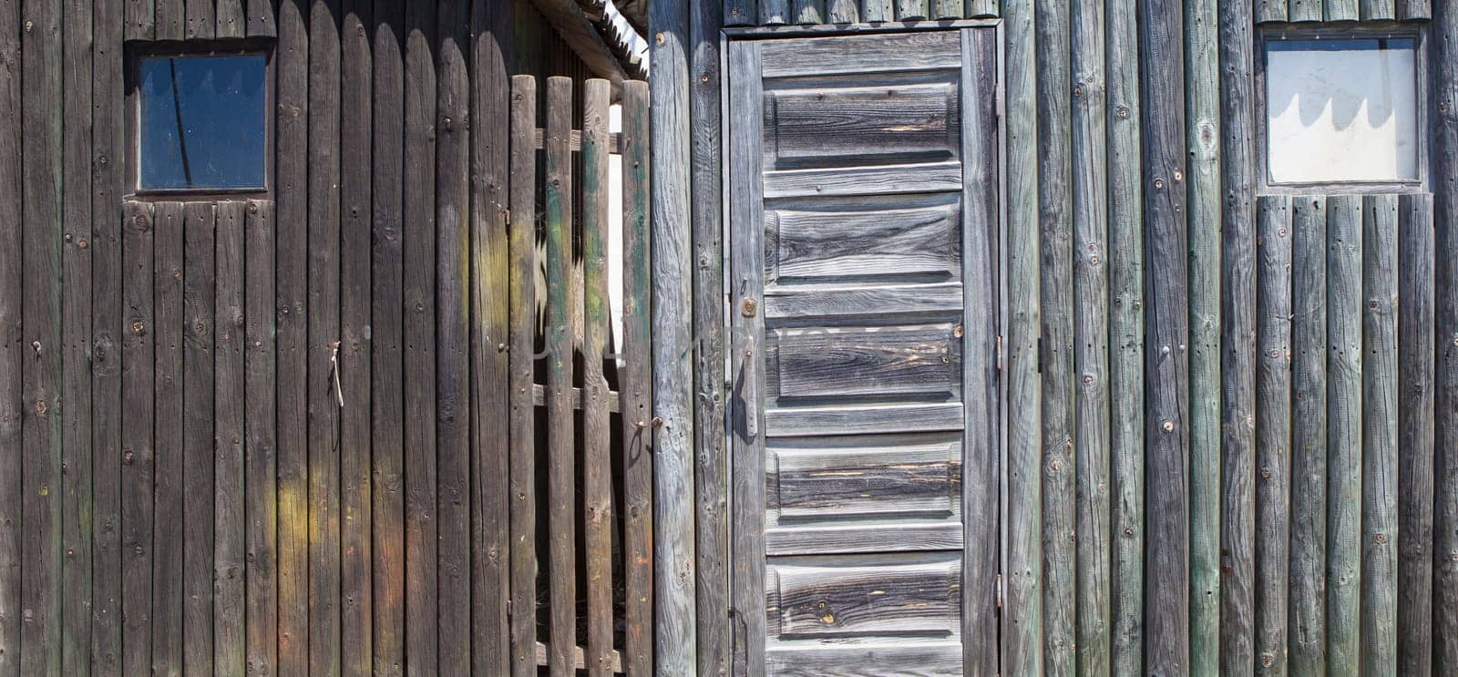 Weathered wooden walls built with logs. Long format