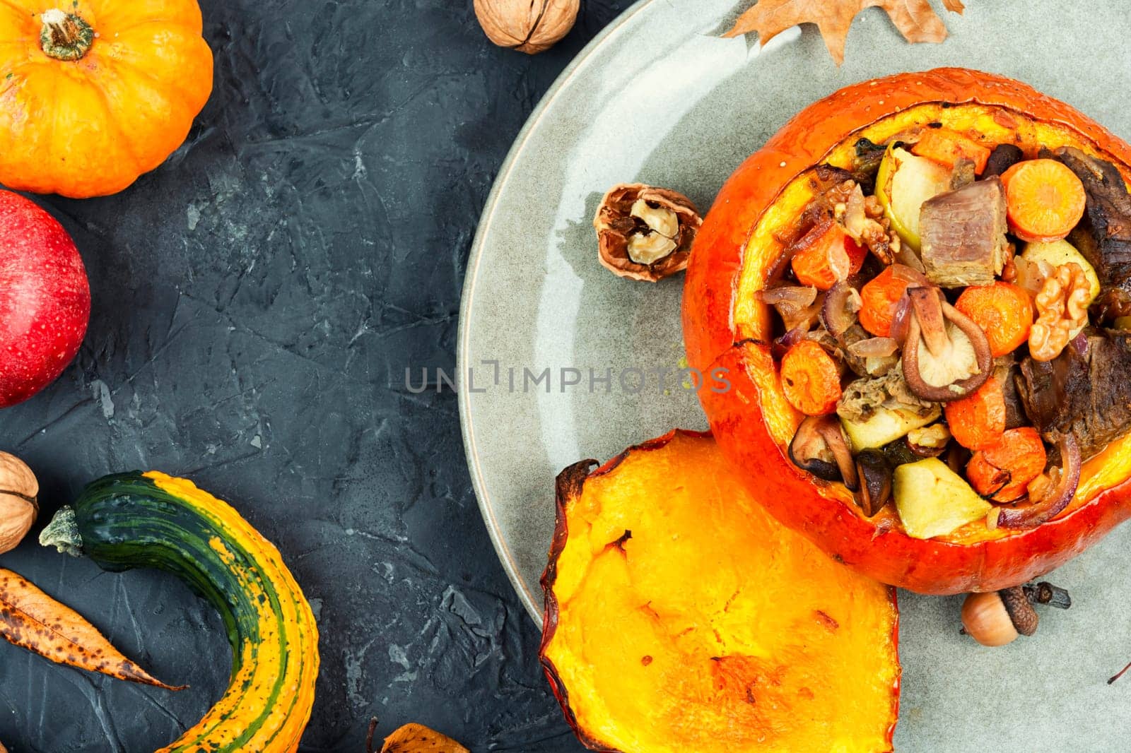 Baked pumpkin stuffed with beef meat, mushrooms, apple and carrots. Halloween food