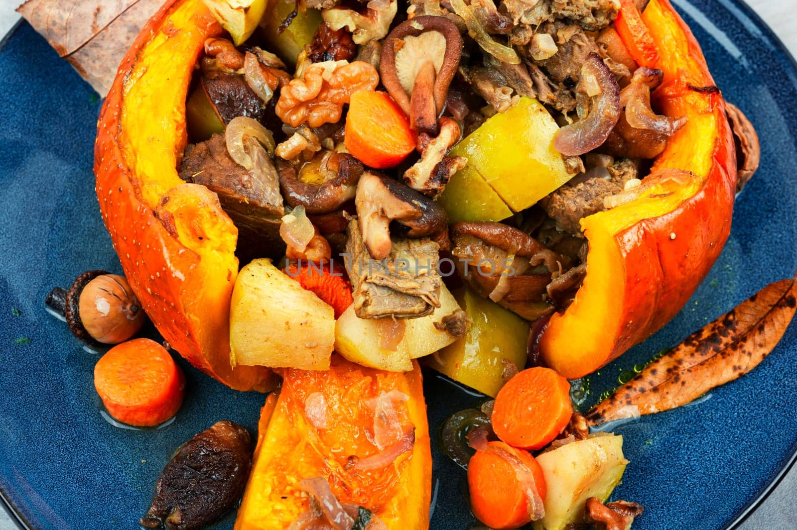 Baked pumpkin stuffed with beef meat, mushrooms, apple and carrots. Halloween food