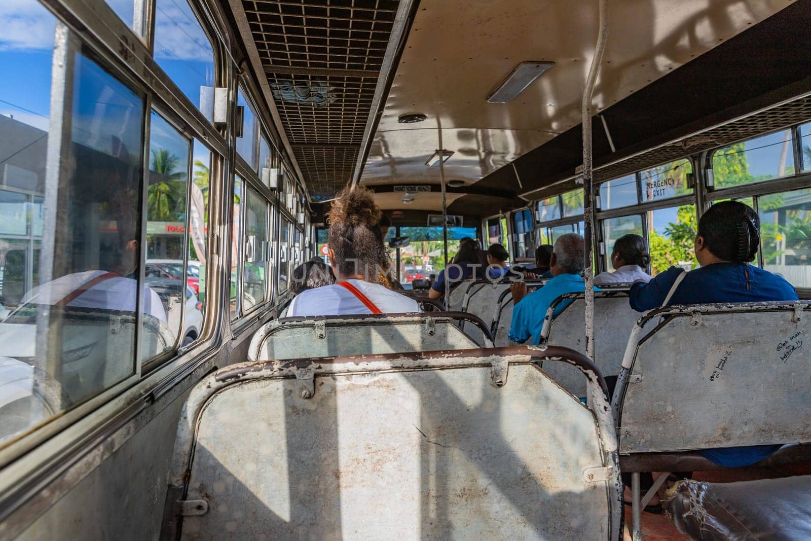 Nadi, Fiji - 23 May 2023: Indigenous Fijian people travel by bus. In Fiji every town and village has a bus stop since this is still the most common form of transportation in the islands.
