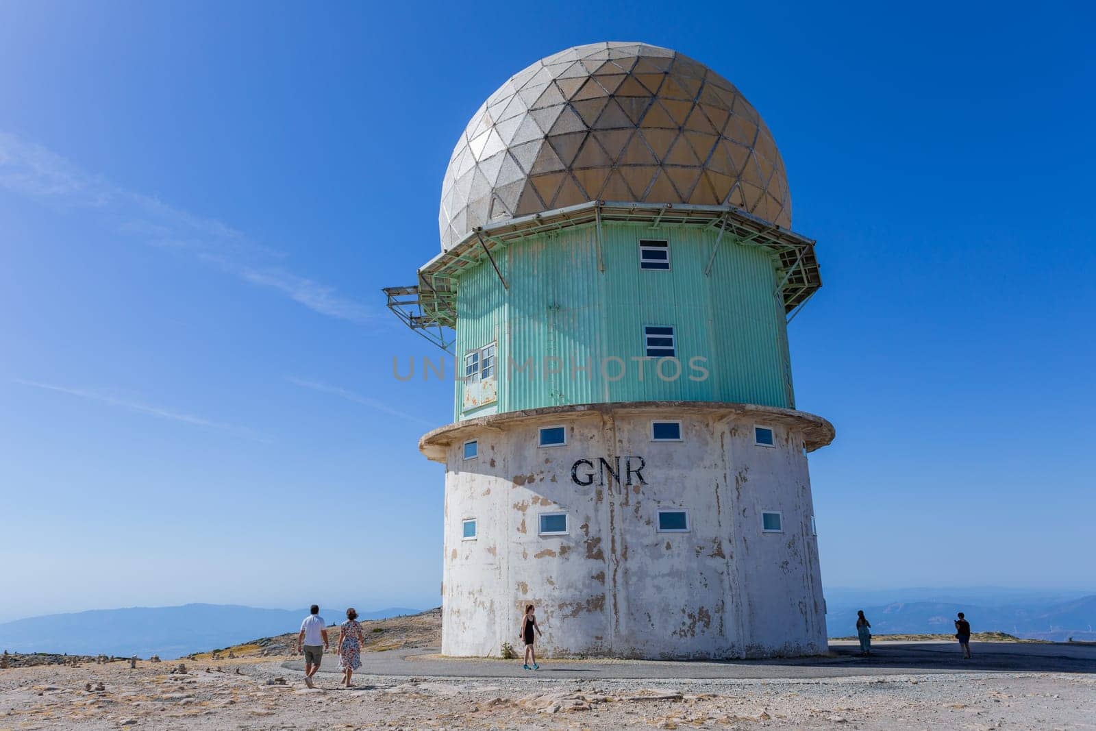Serra da Estrela, Portugal: 22 August 2023: People in Torre and transmitting towers with golden cupola, the highest point of Portugal, in Serra da Estrela