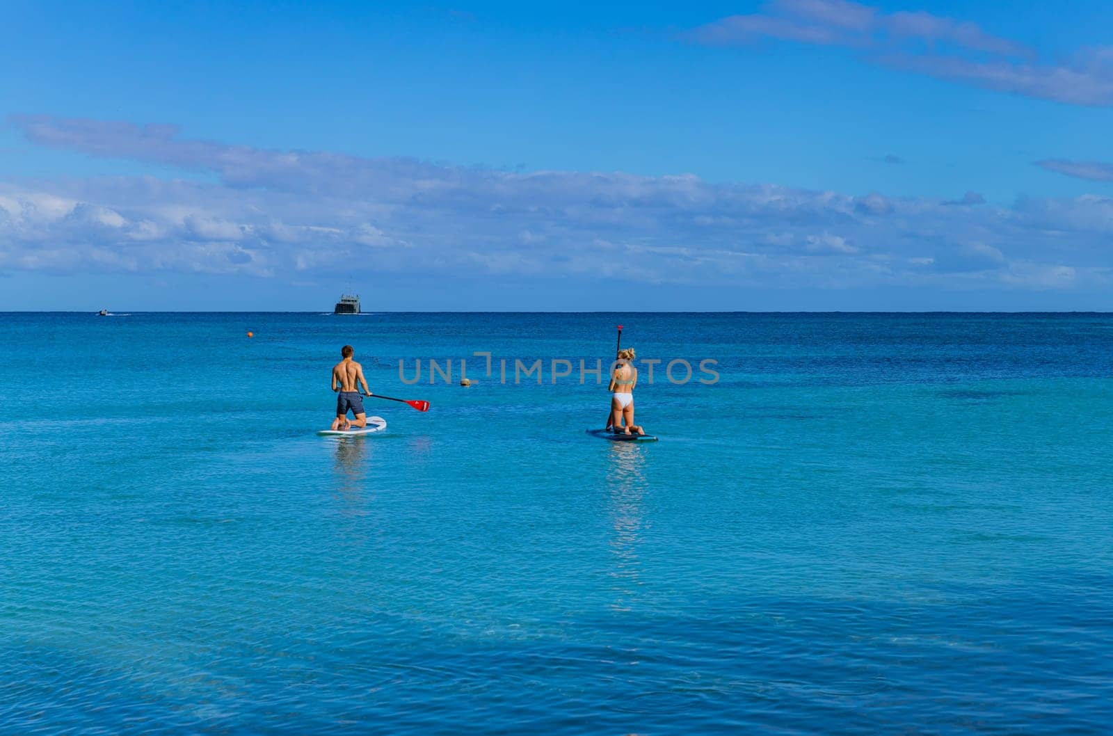 Viti Levu, Fiji: 26 May 2023: happy couple enjoying stand up paddling during summer vacation. Viti Levu, Fiji