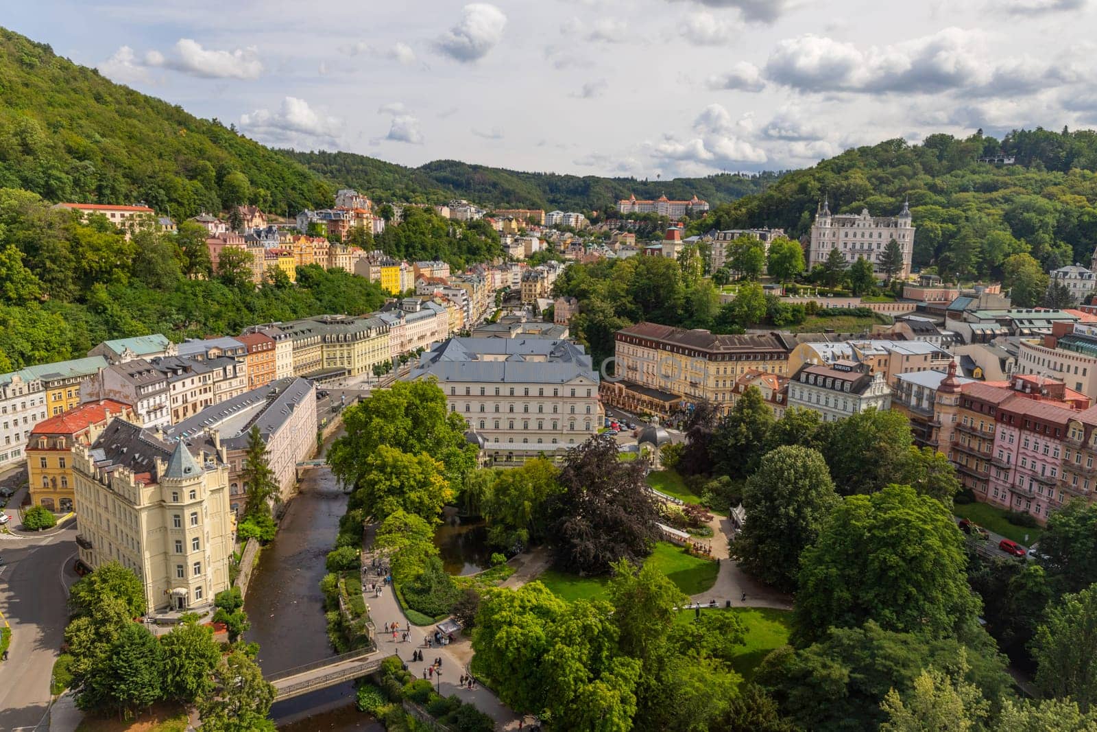 Karlovy Vary, Czech Republic: August 7, 2023. View of street with colorful riverfront houses in Czech famous spa city. Romantic architecture of Bohemia. Urban scene
