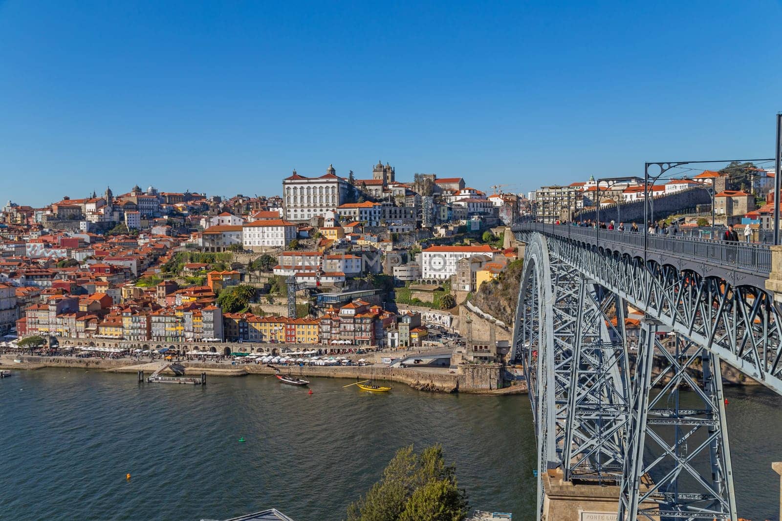 Porto, Portugal - March 02, 2023: View of Ribeira historical quarter on the margin Douro river embankment in the old town and Luis I bridge, Porto, Portugal.