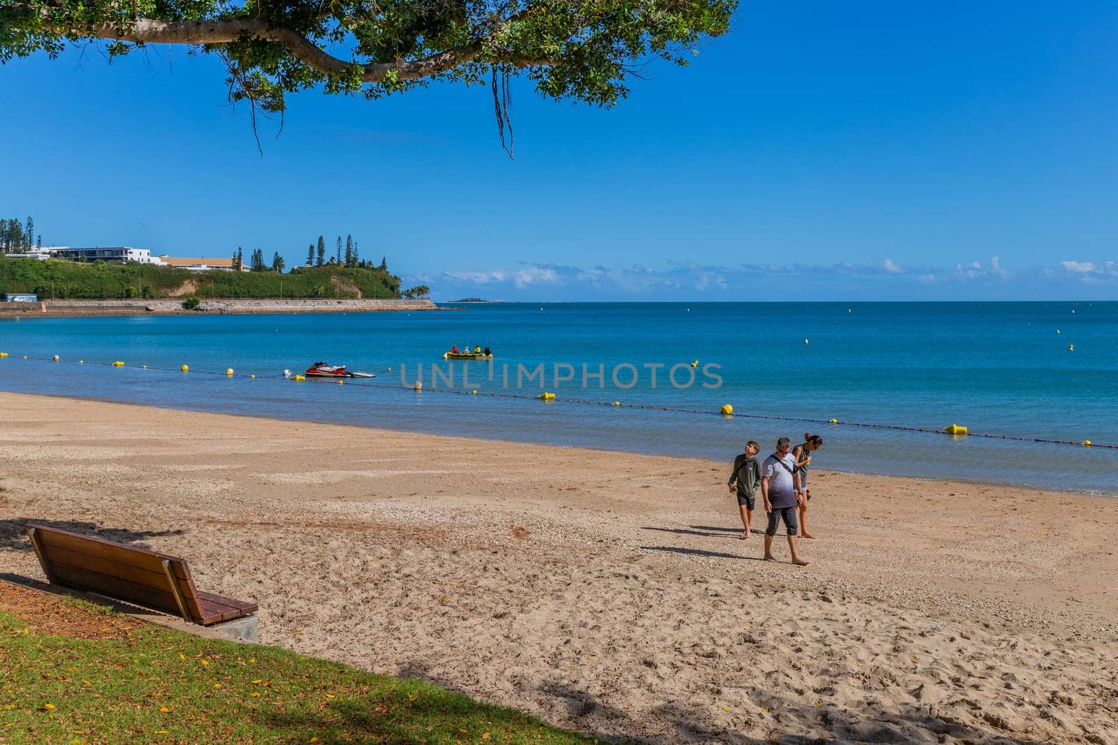 Noumea New Caledonia - 03 June 2023: People relaxing in the afternoon sun at the Beach in Noumea, New Caledonia.