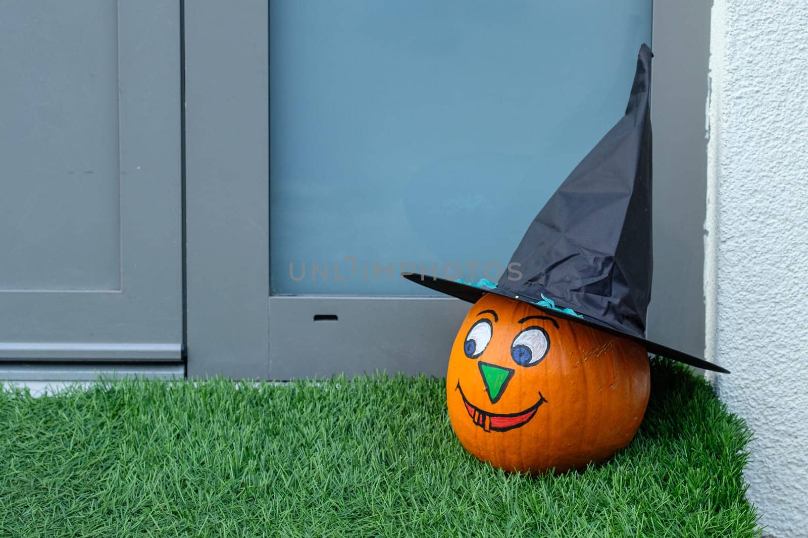 Laughing halloween pumpkin with black hat
