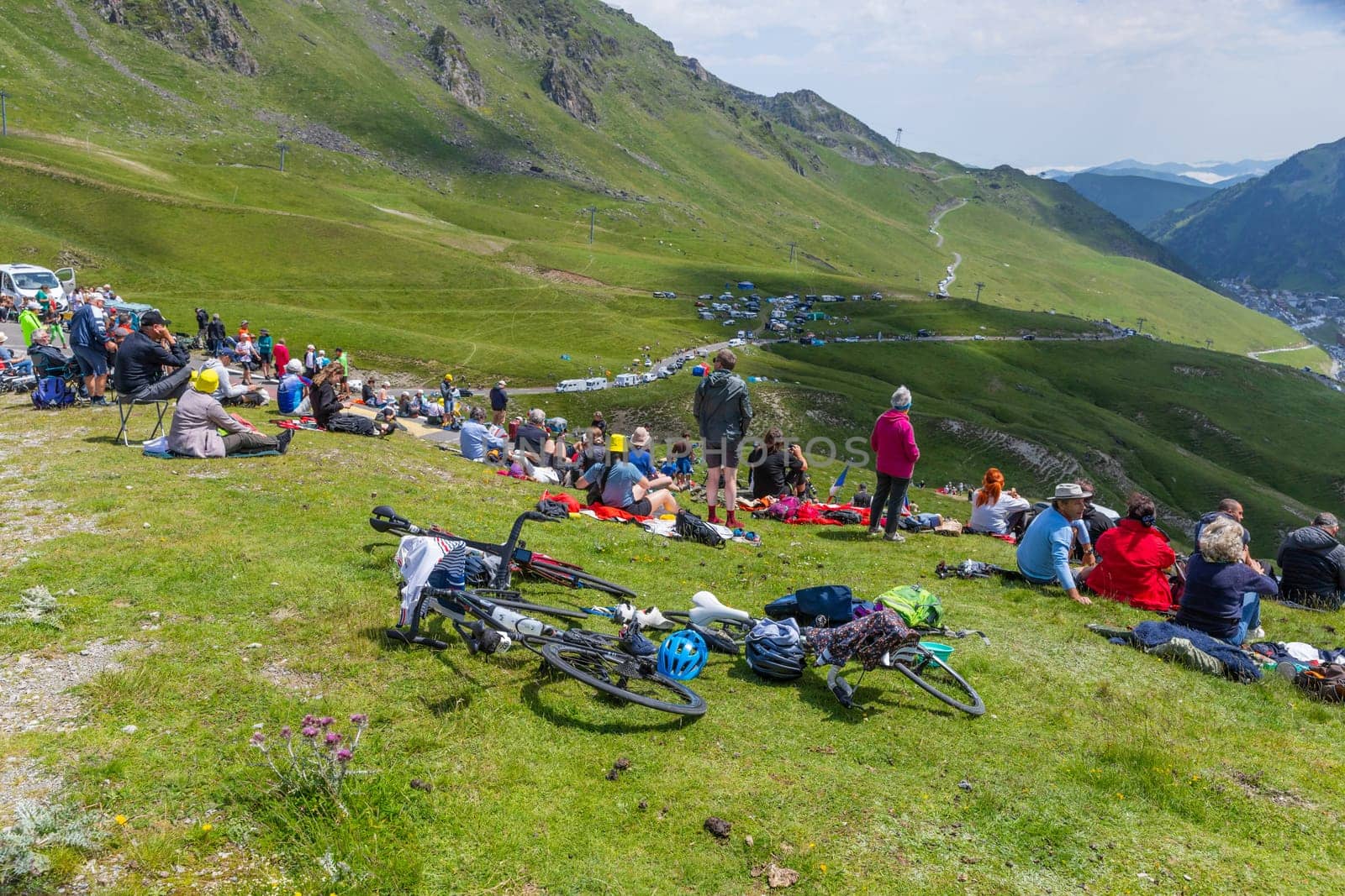 Col du Tourmalet, France - July 06 2023: Cycling fans waiting for the buch at the top of the Col du Tourmalet in Pyerenees mountains during the stage 6 of Le Tour de France 2023