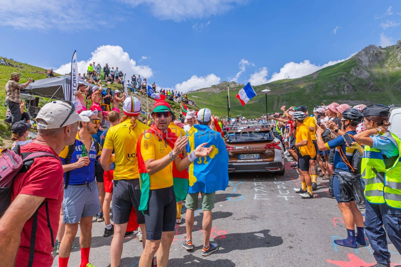 Col du Tourmalet, France - July 06 2023: Cycling fans waiting for the buch at the top of the Col du Tourmalet in Pyerenees mountains during the stage 6 of Le Tour de France 2023