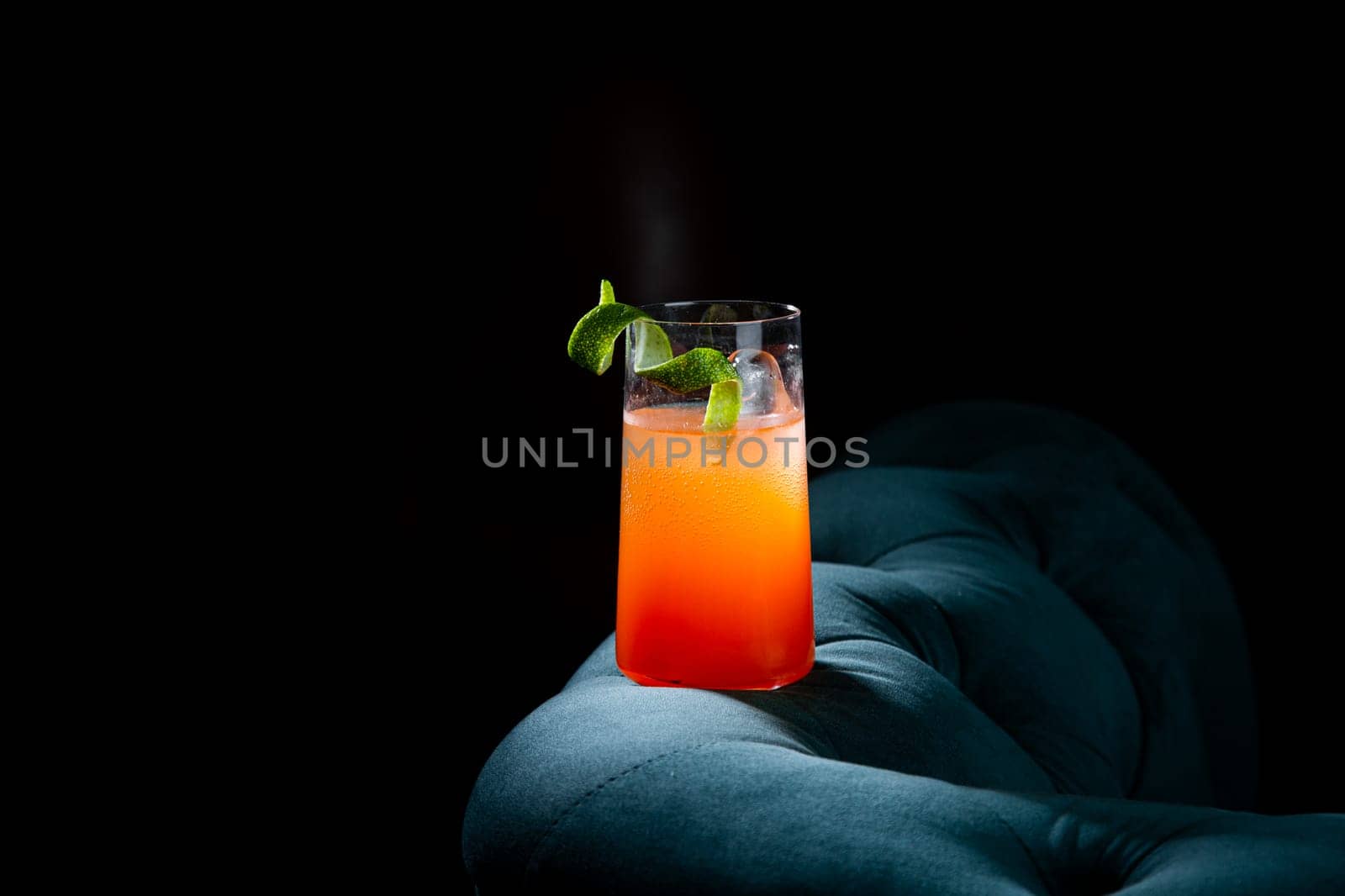 tropical cocktail with sunset gradient and citrus