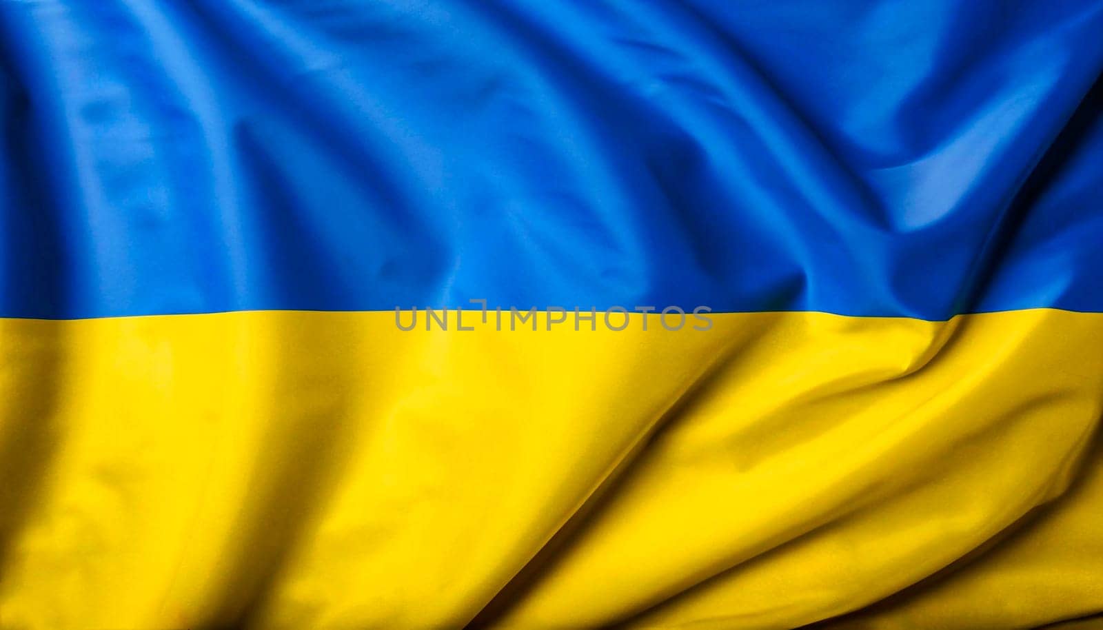 Close up of the Ukraine flag on a ruffled mesh fabric. Curves and folds of the satin fabric with texture. Selective focus and depth of field. Democracy and politics.