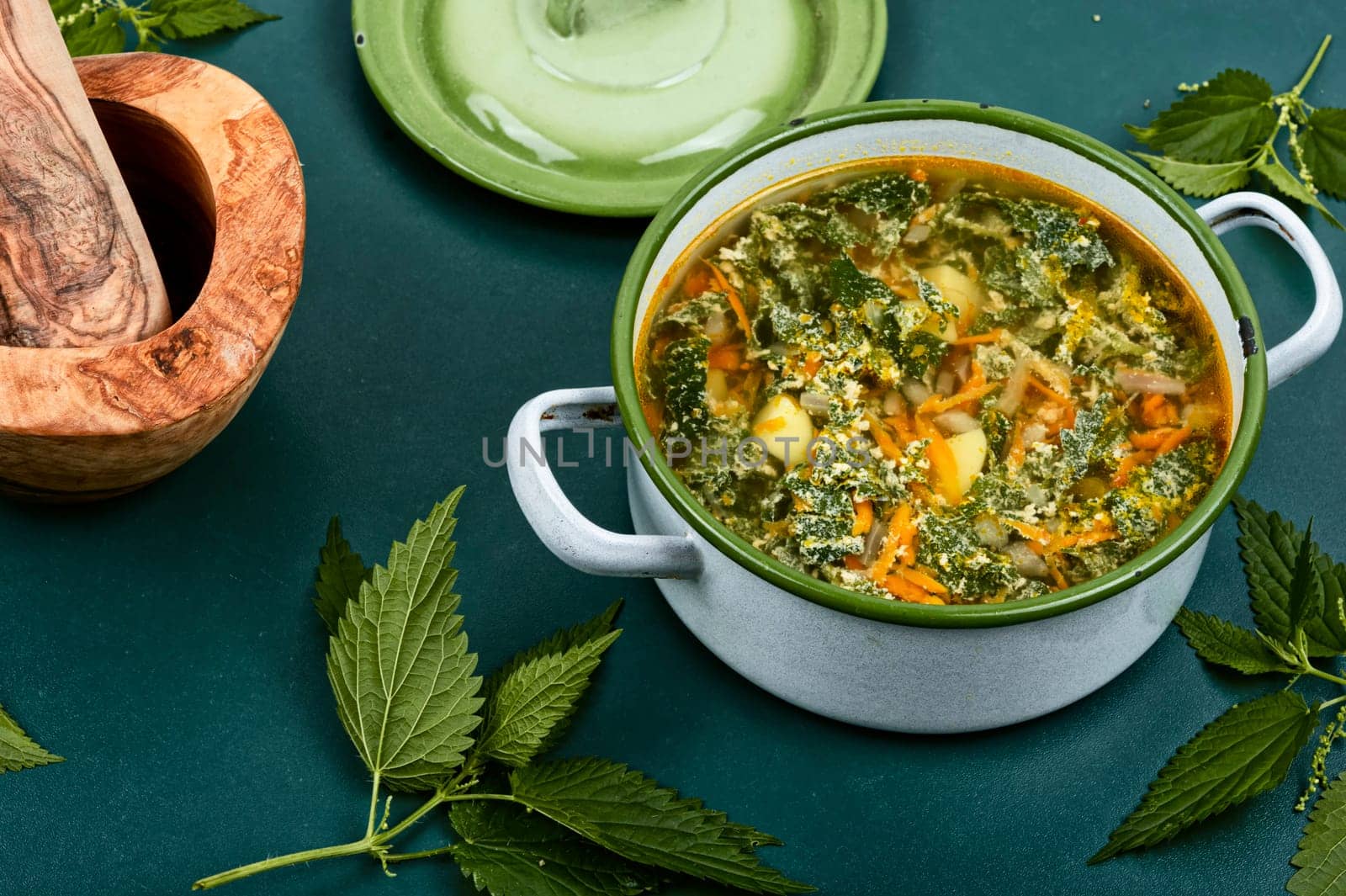 Nettle soup in a saucepan. Stinging nettle soup. Healthy food, copy space.