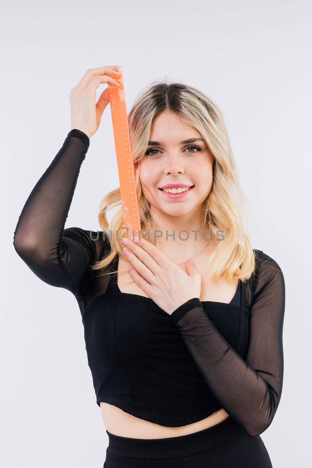 Young woman, female patient isolated on a white studio background. Correction of asymmetry concept.