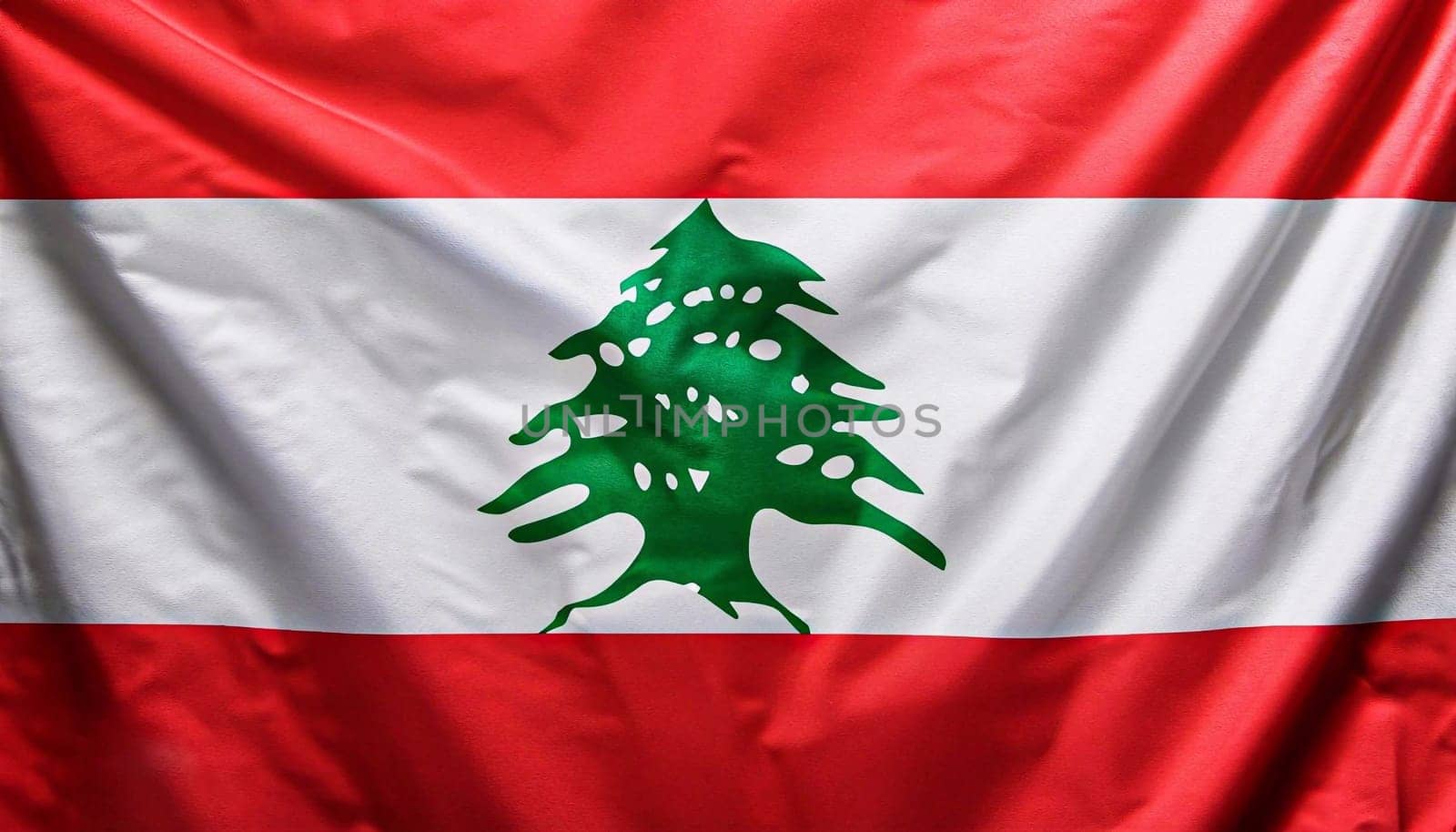 Lebanon flag with big folds waving close up under the studio light indoors. The official symbols and colors in fabric banner