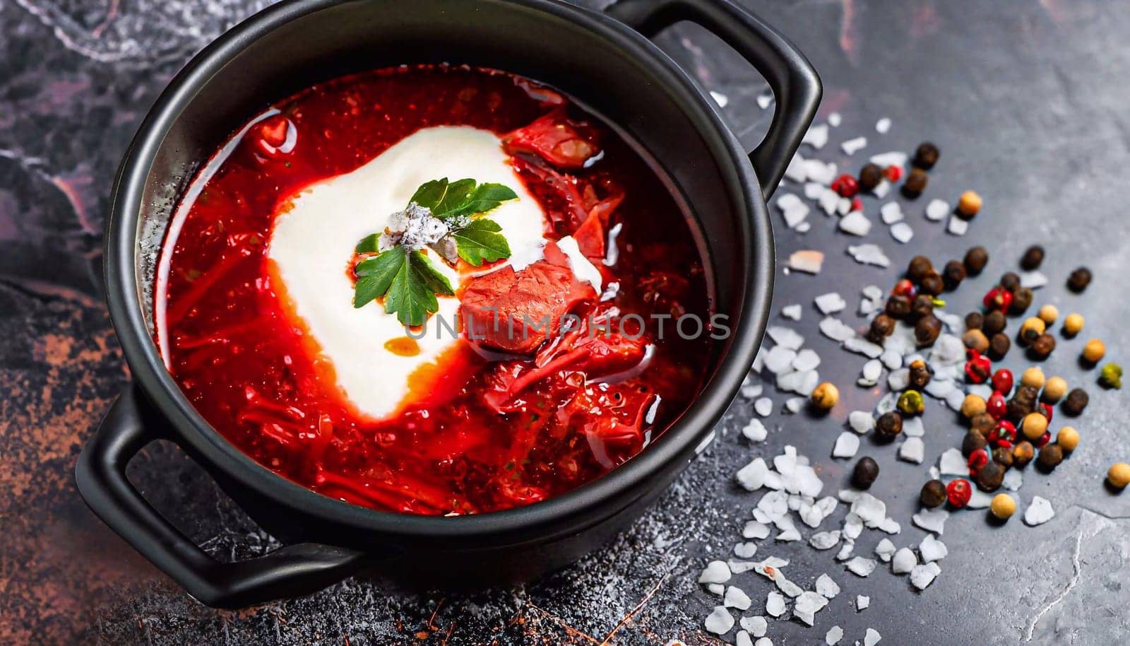 Traditional Ukrainian Russian borscht on a light background. Borscht with sour cream. Beetroot borscht with parsley. High quality photo