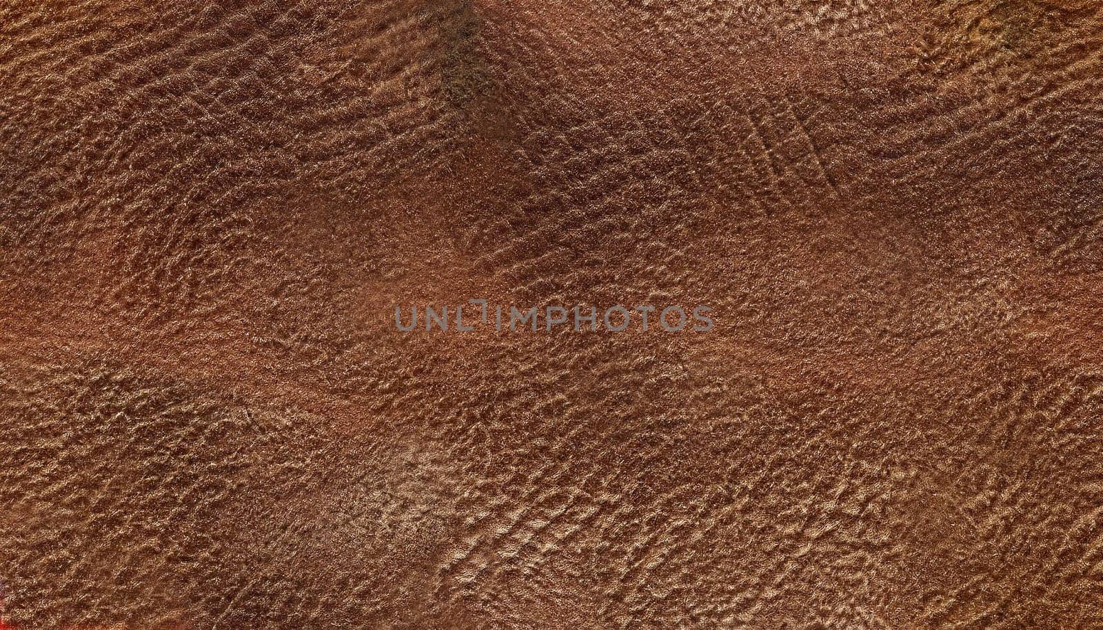dark brown leather texture closeup can be used as background.