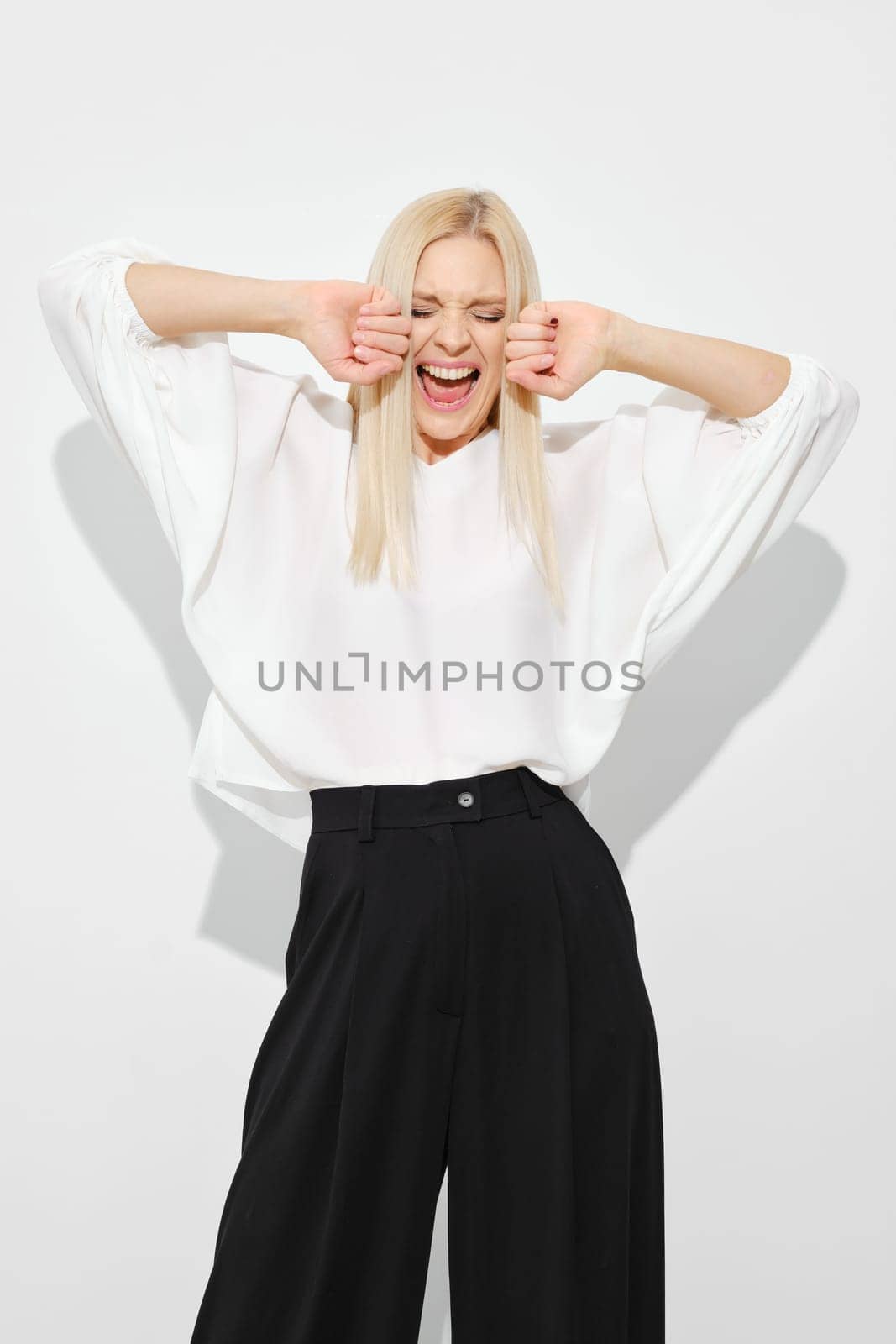 Woman screaming with joy or happiness on white background