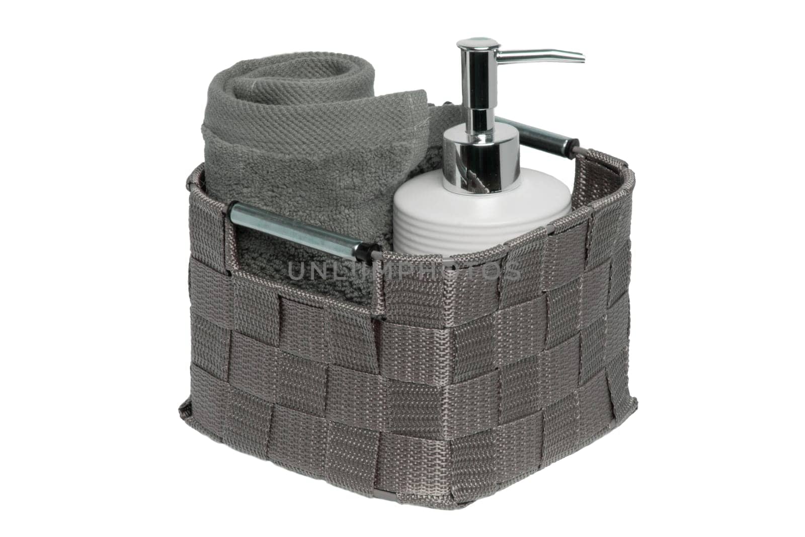 Basket with a fresh soft terry bath towel and a soap bottle isolated on a white background. Beaty and wellness. Macro.