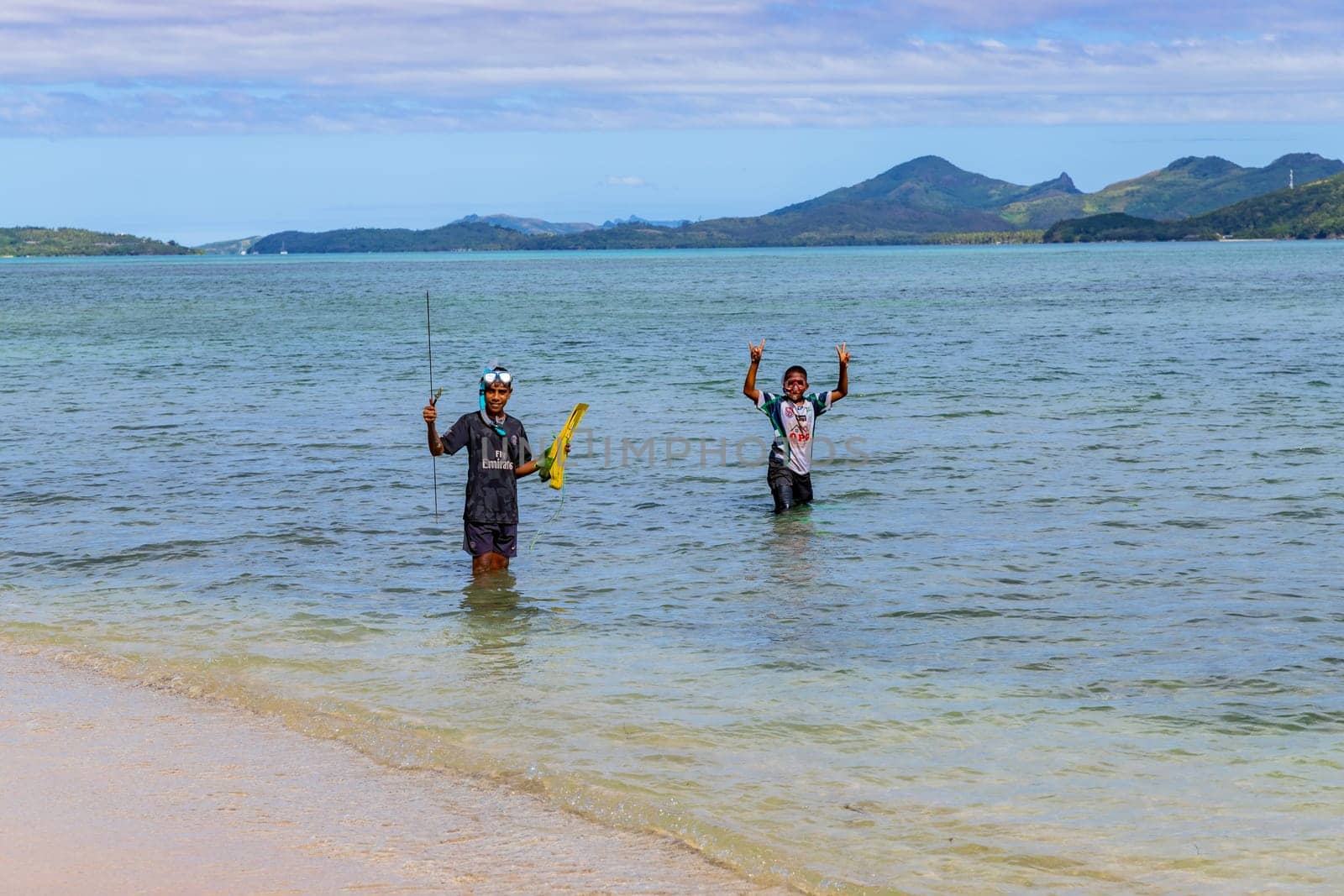 Nacula, Fiji: 26 May 2023: Local kids fishing at the beach, Nacula island in Fiji.