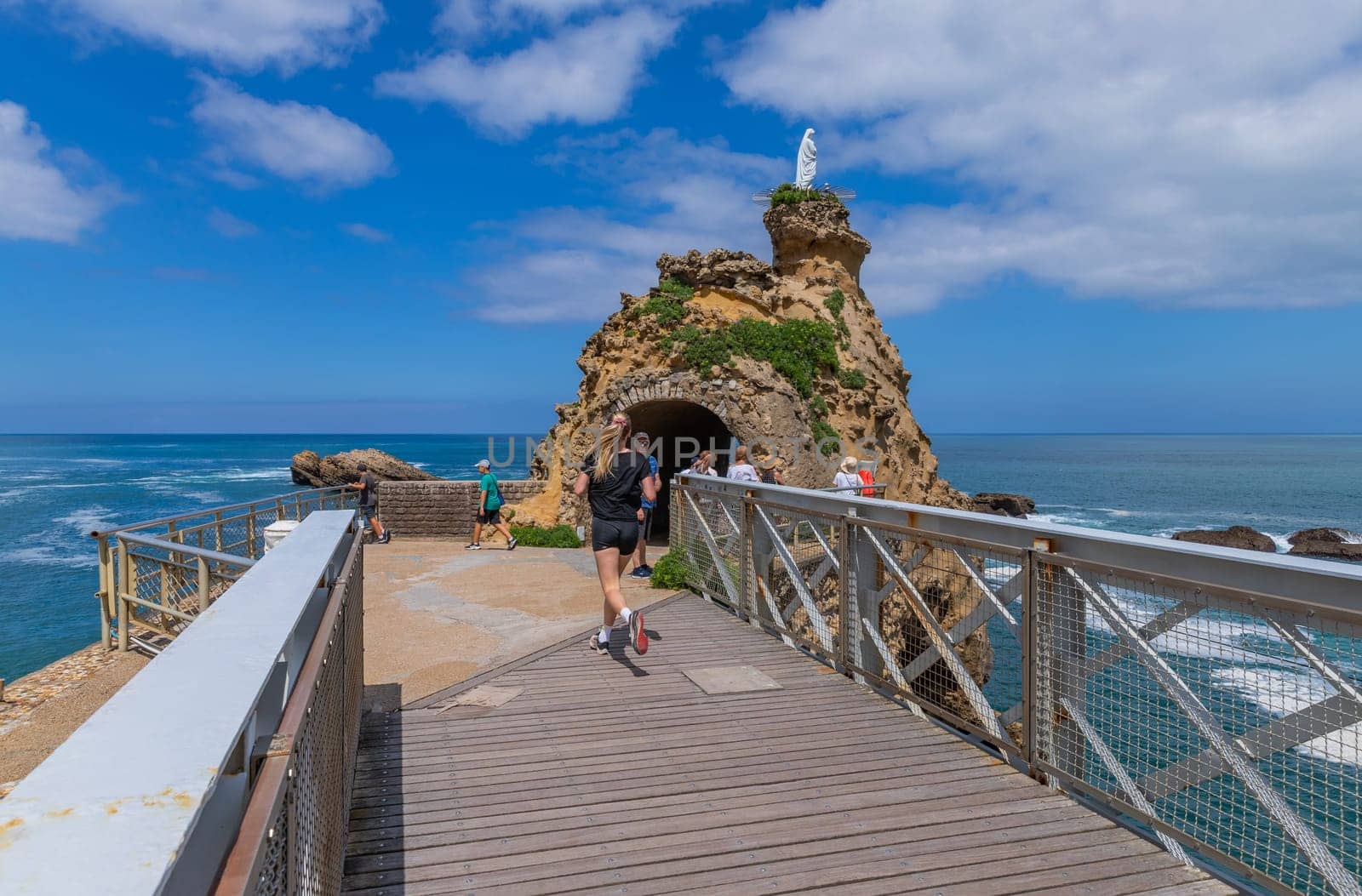 Biarritz, France, July 03, 2023: Tourists at the rocher de la vierge (virgin mary rock) in Biarritz. Aquitaine, Basque Country, France.