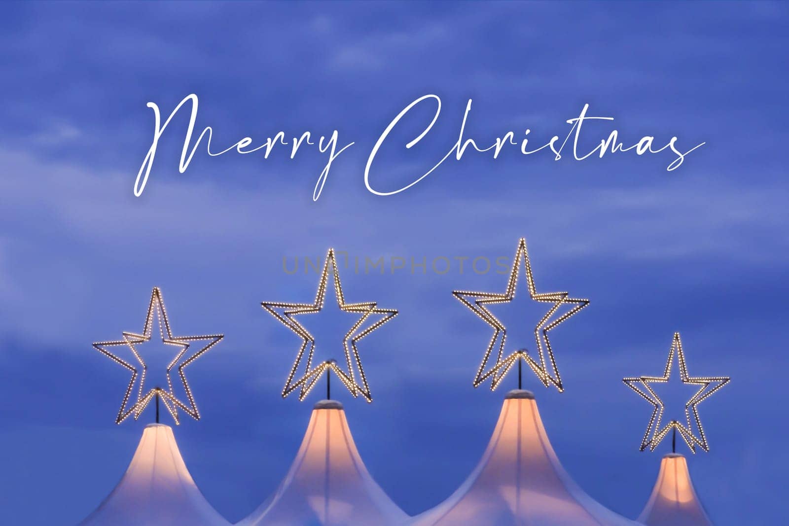 Wonderful x-mas season scene for visual or greetings card. Beautiful market tents with magic orange stars and blue sky at evening time.