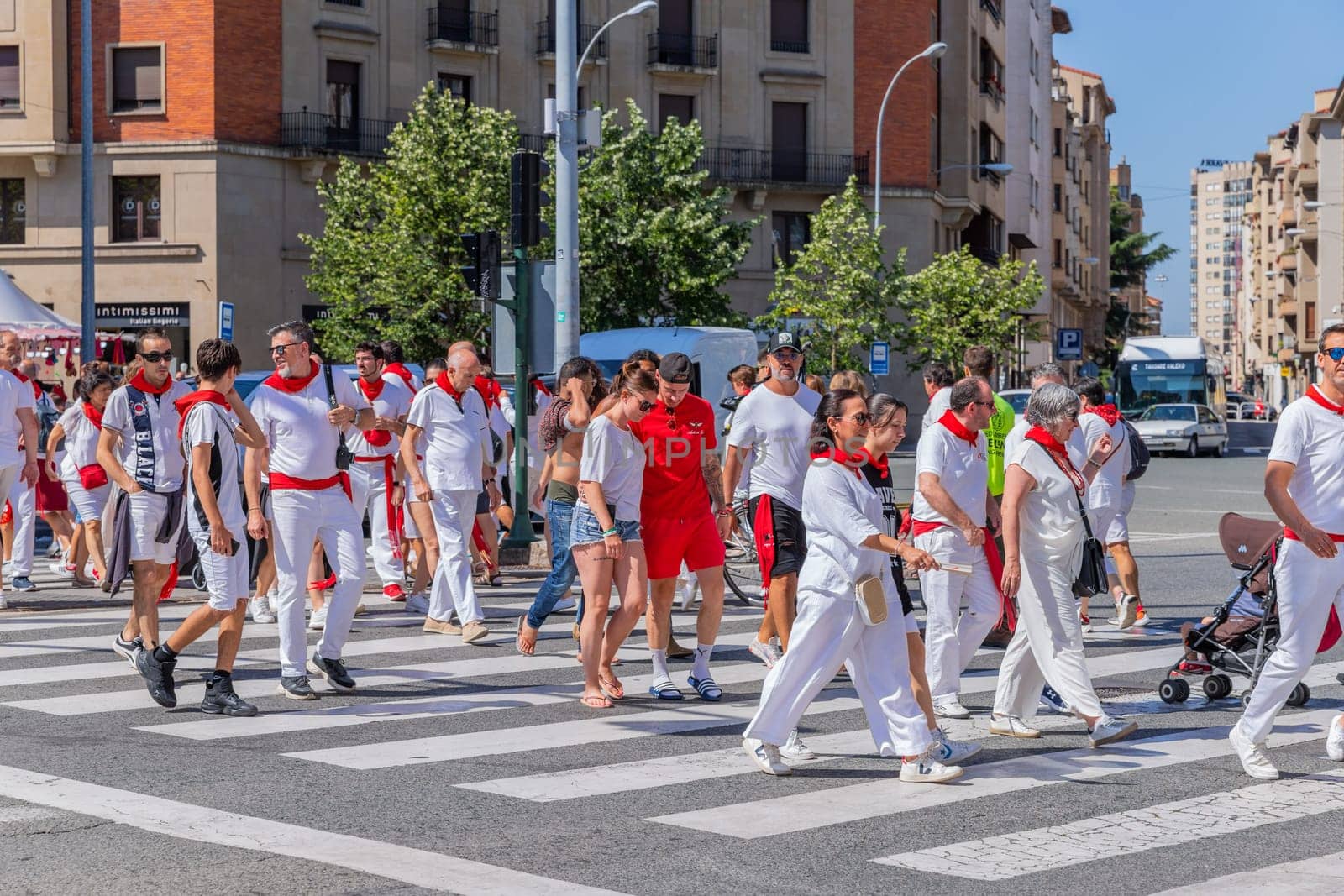 Pamplona, Spain: 09 July 2023: People celebrate San Fermin festival in traditional white abd red clothing with red necktie, Pamplona, Navarra, Spain.