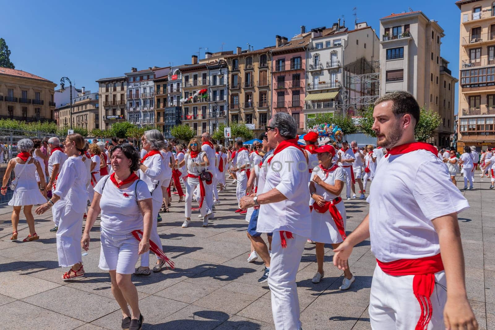 Pamplona, Spain: 09 July 2023: People celebrate San Fermin festival in traditional white abd red clothing with red necktie, Pamplona, Navarra, Spain.