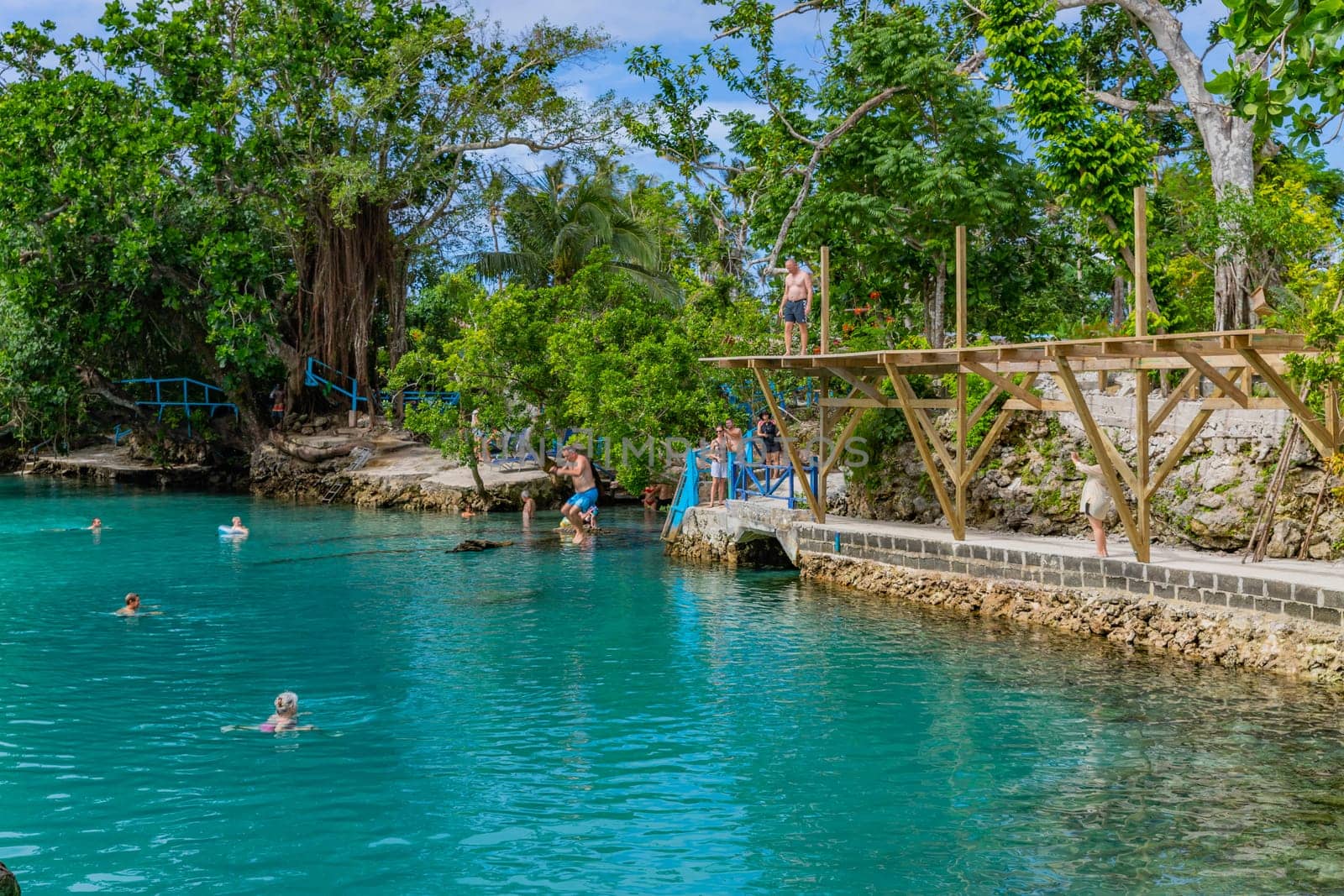 Port Vila, Vanuatu: 01 June 2023: People swimming in Blue Lagoon, a popular scenic turquoise swimming hole near Port Vila, Efate Island, Vanuatu, Melanesia