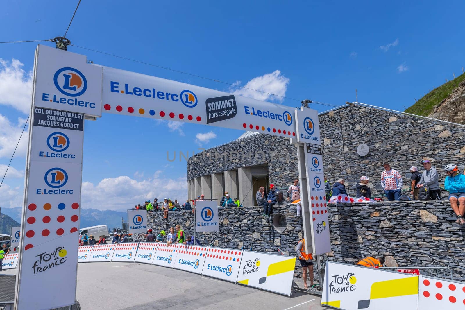 Col du Tourmalet, France - July 06 2023: Cycling fans waiting for the buch at the top of the Col du Tourmalet in Pyerenees mountains during the stage 6 of Le Tour de France 2023