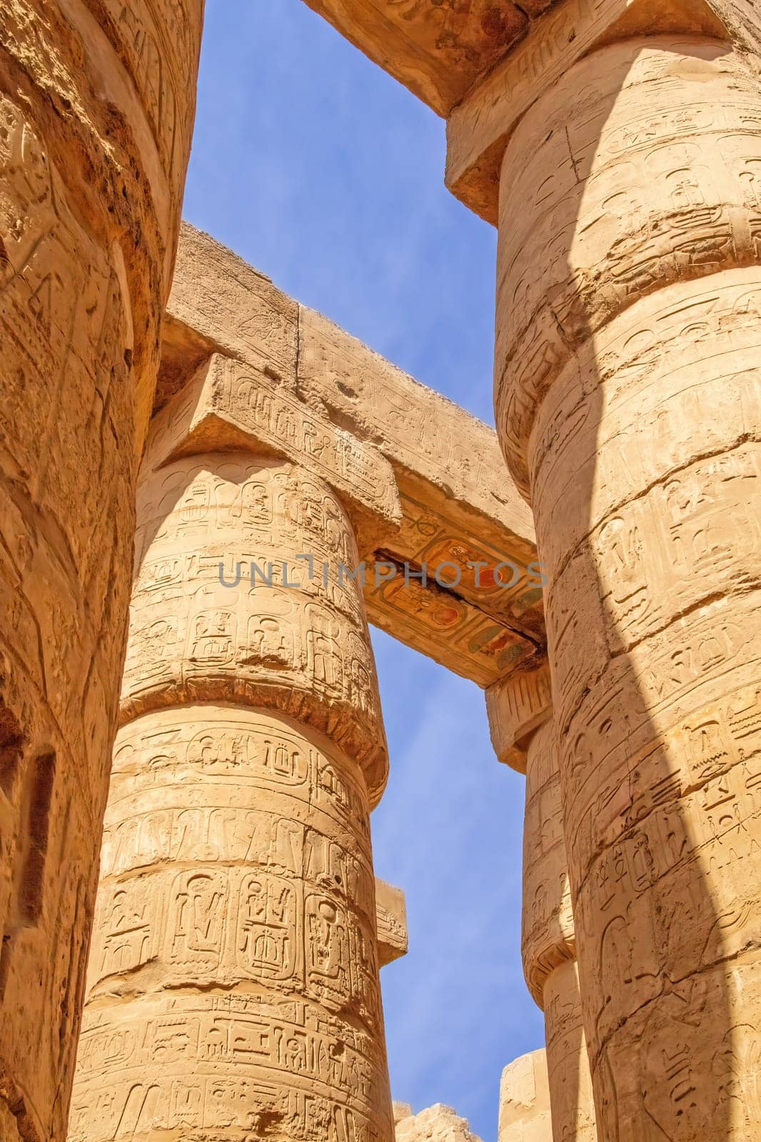 Columns at the Temples of Karnak.  Blue sky in the background. Luxor, Egypt. Vertically.