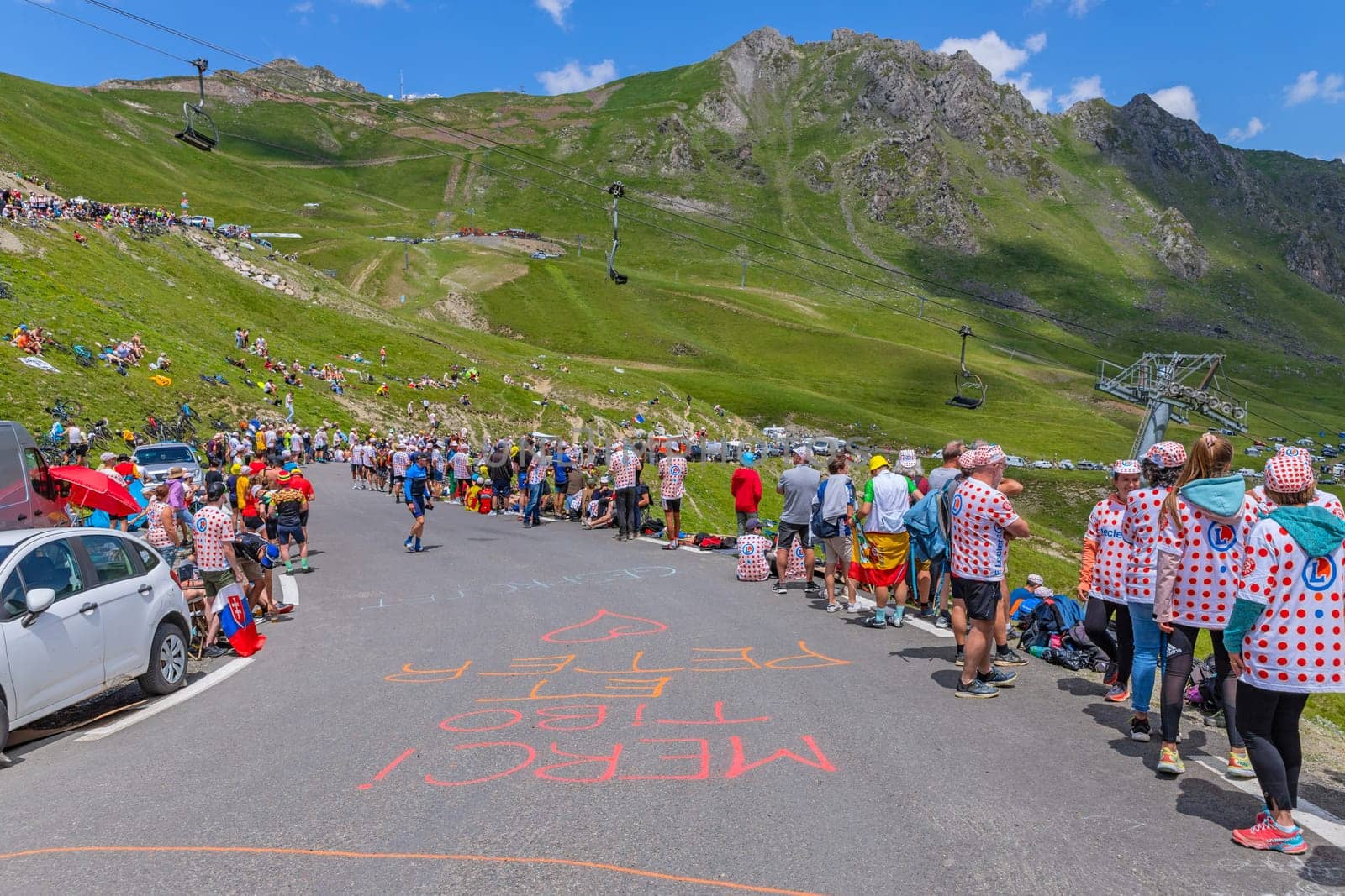 Col du Tourmalet, France - July 06 2023: Cycling fans waiting for the buch at the top of the Col du Tourmalet in Pyerenees mountains during the stage 6 of Le Tour de France 2023