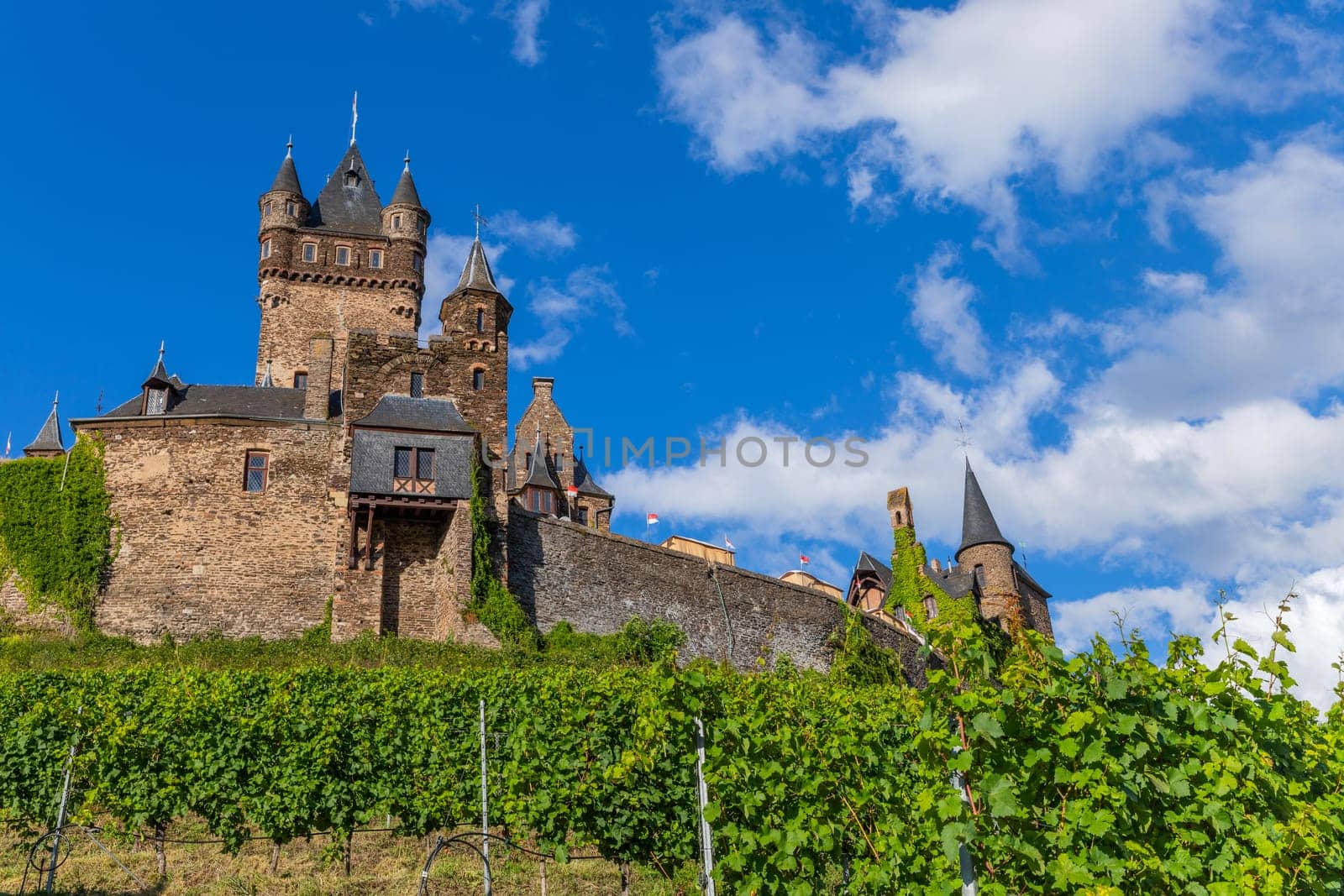 Cochem, Germany, August 10, 2023. Beautiful view of the hilltop castle (Reichsburg Cochem) in the touristic town of Cochem on the Moselle River in Rhineland-Palatinate in Germany.