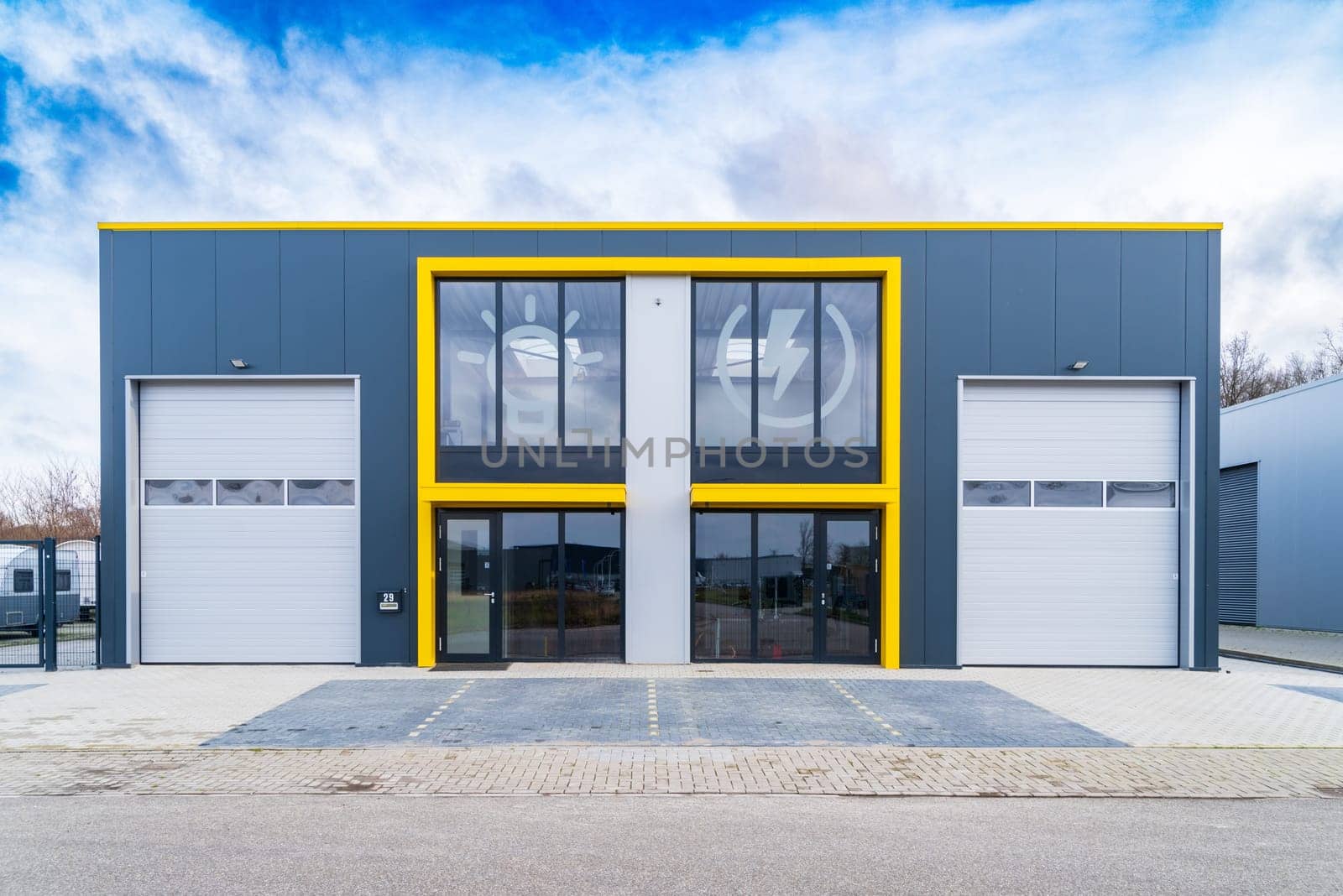 HENGELO, NETHERLANDS - JANUARY 30, 2021: Modern office building combined with a small warehouse unit