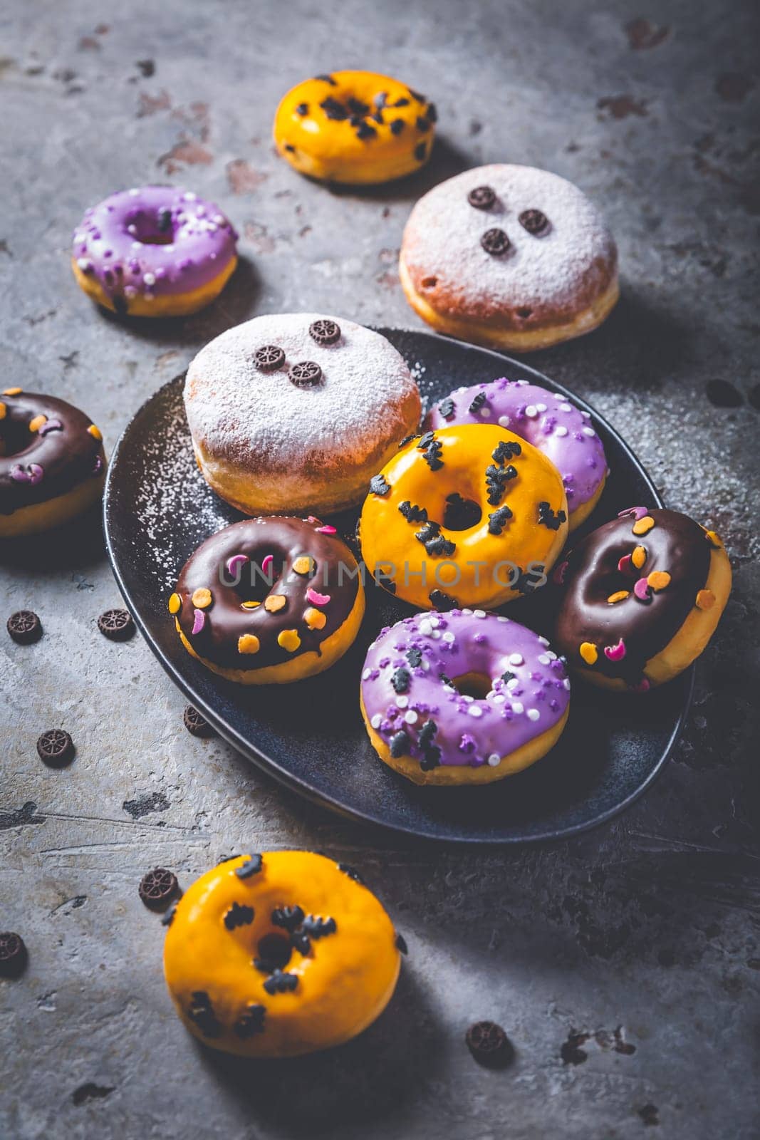 Halloween donuts and Berliner with assorted frosting and sugar sprinkles for Halloween and carnival