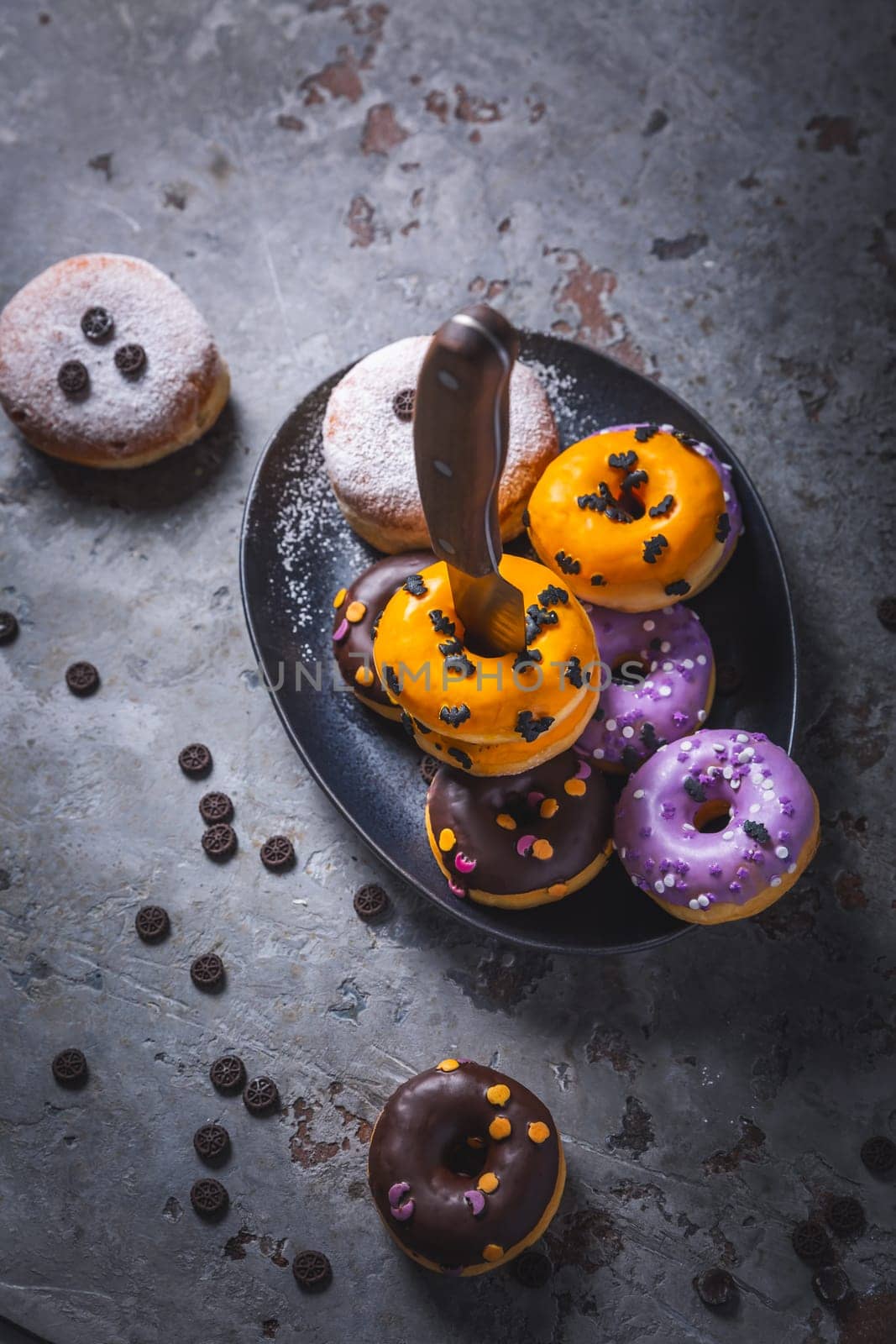 Halloween donuts and Berliner with assorted frosting and sugar sprinkles for Halloween and carnival