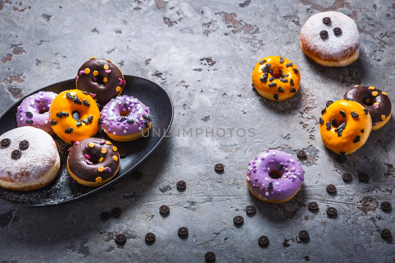Halloween donuts and Berliner with assorted frosting and sugar sprinkles for Halloween and carnival
