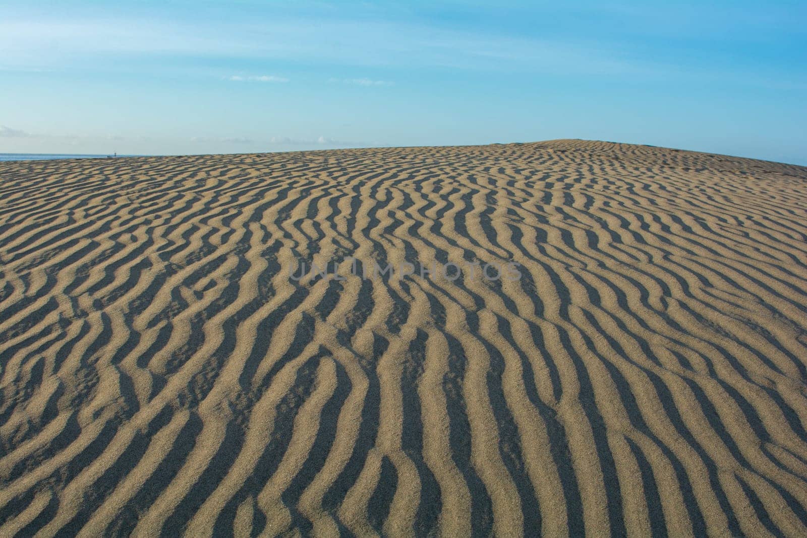 Lines in the desert sand with blue sky